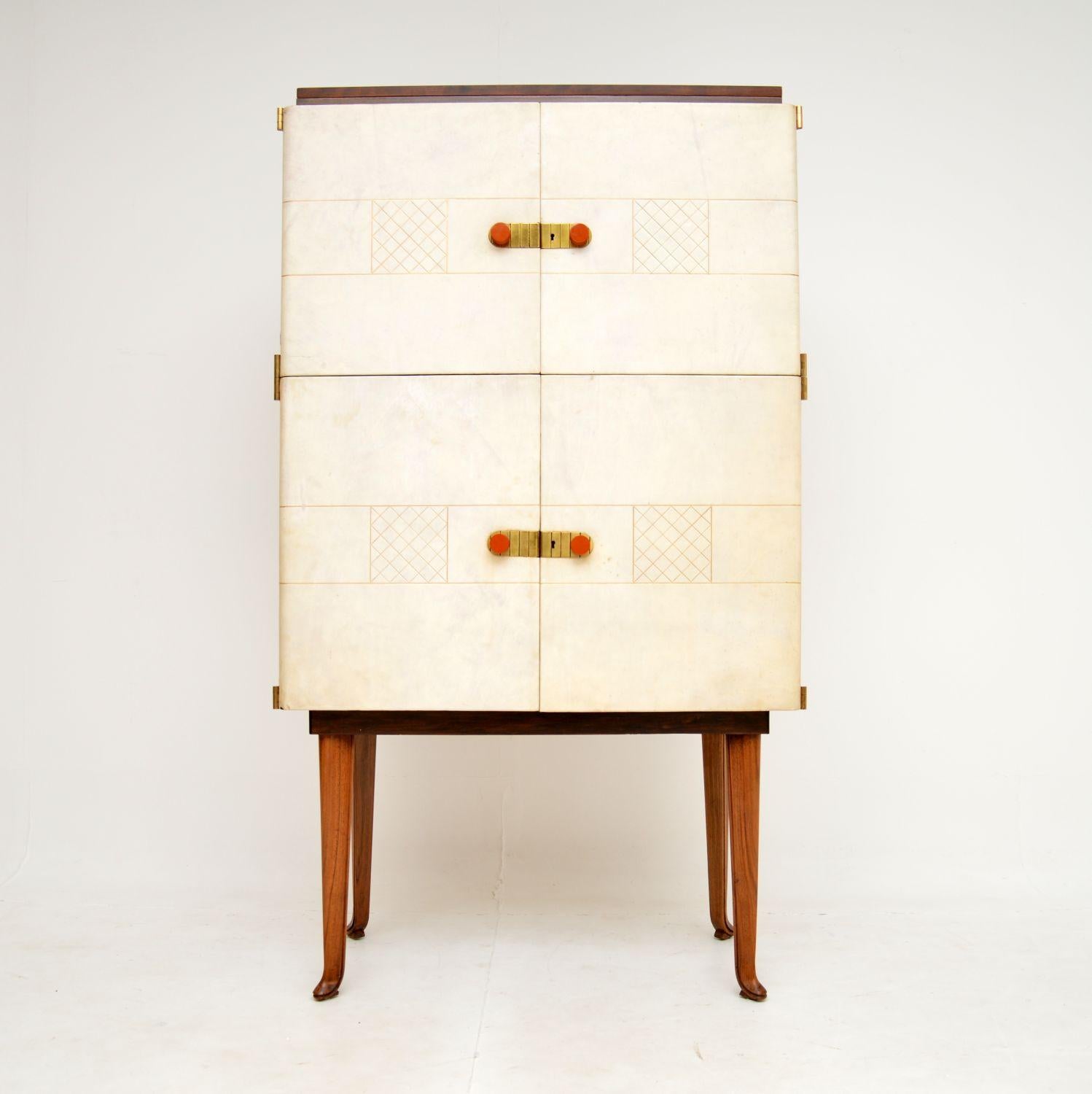 A fantastic vintage drinks cabinet in walnut and leather. This was made in London by Laszlo Hoenig, it dates from the 1950’s.

The quality is exceptional, this has a gorgeous and very unique design. The front is leather clad, with beautiful gold
