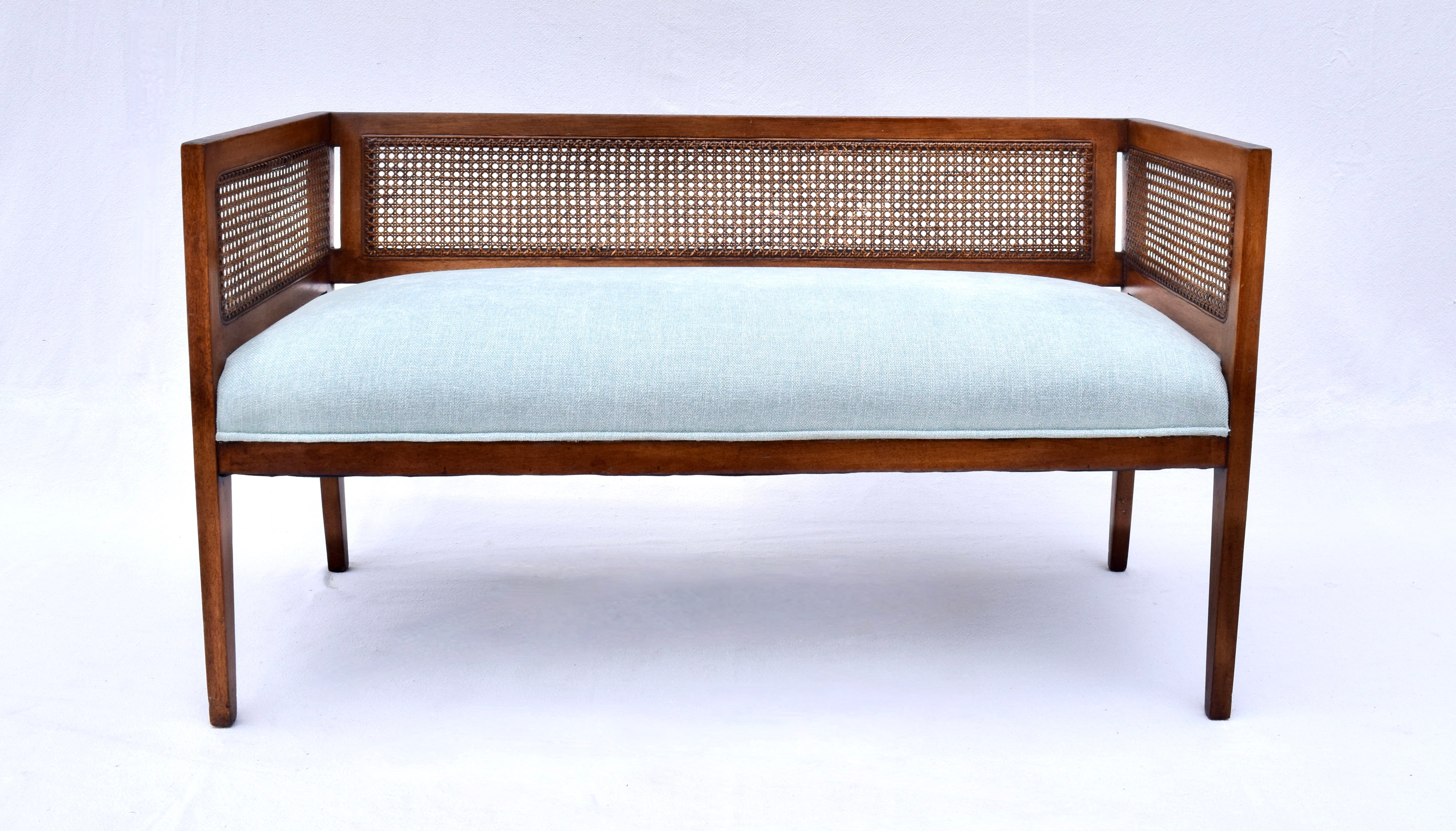 Solid Mahogany Mid-Century Modern window bench or settee in the manner of Edward Wormley for Dunbar. Beautifully maintained all original caning and finish with warm patina. Restored seat and bolster cushions are upholstered is soft blue Chenille.