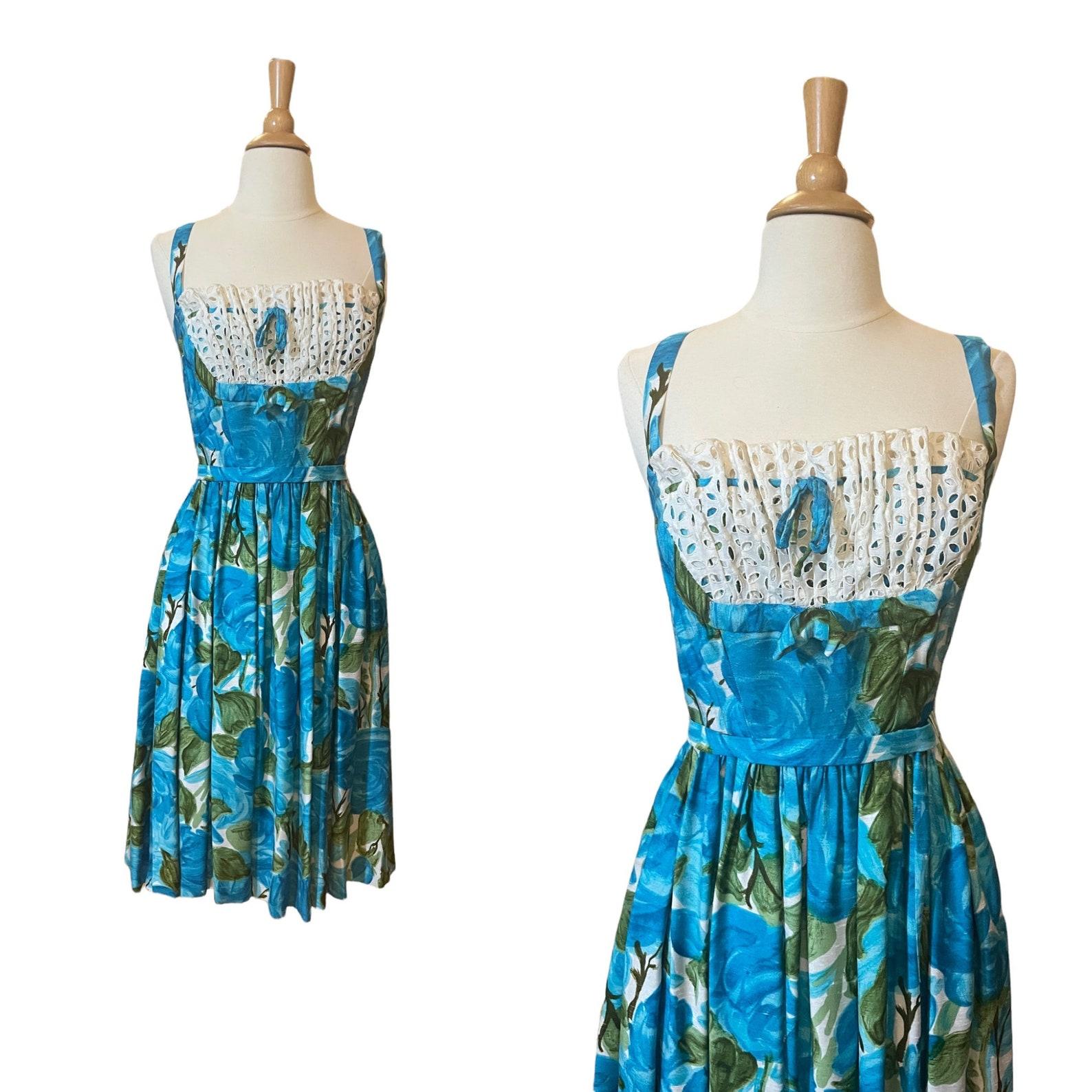 vintage blue & green watercolor floral & leaf print dress. fit and flair silhouette. white eyelet lace ruffled 