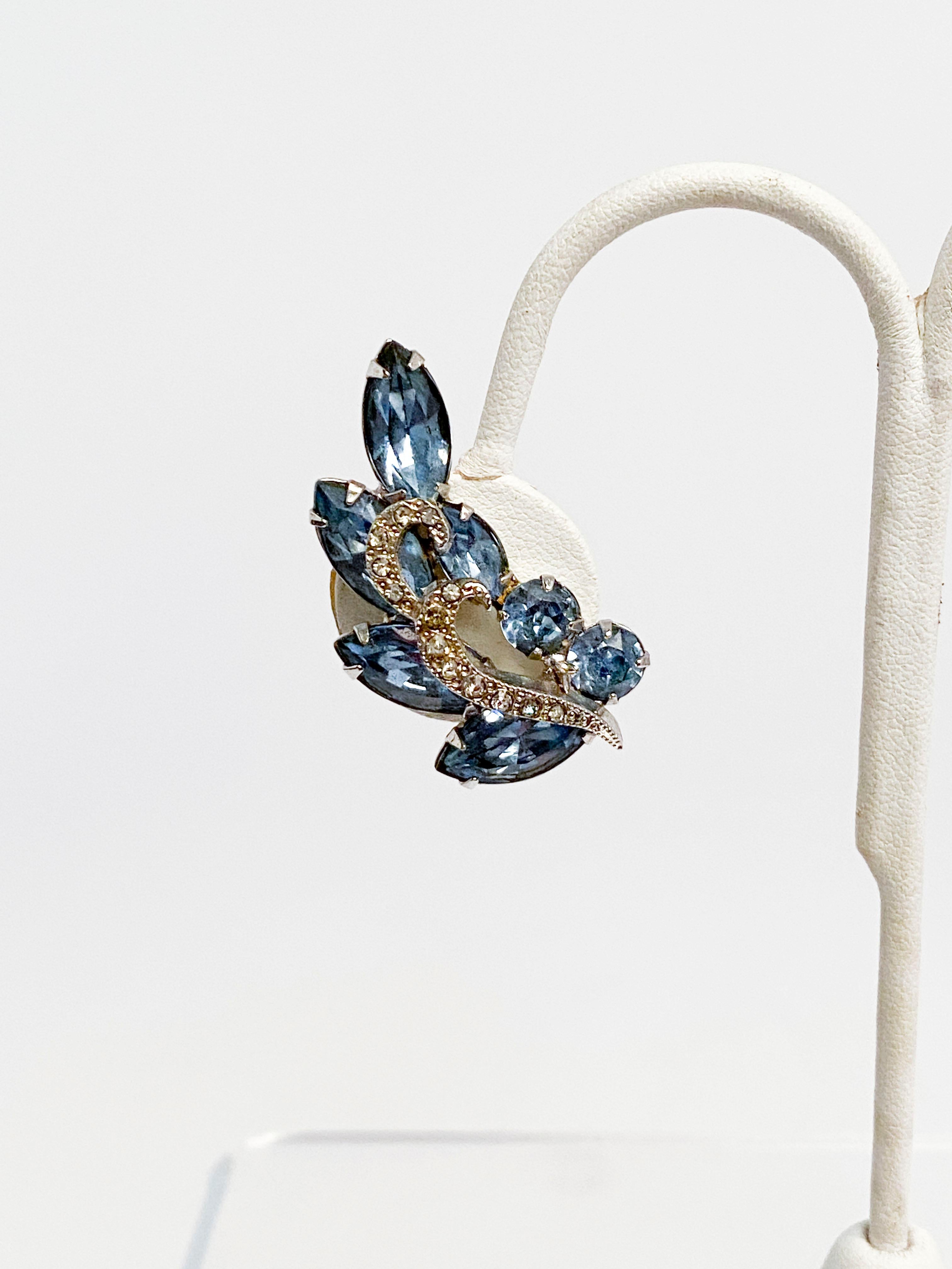 1950s Weiss clip-on earrings adorned with clear and light blue rhinestones. Shaped to be fixed along the side of the ear. 