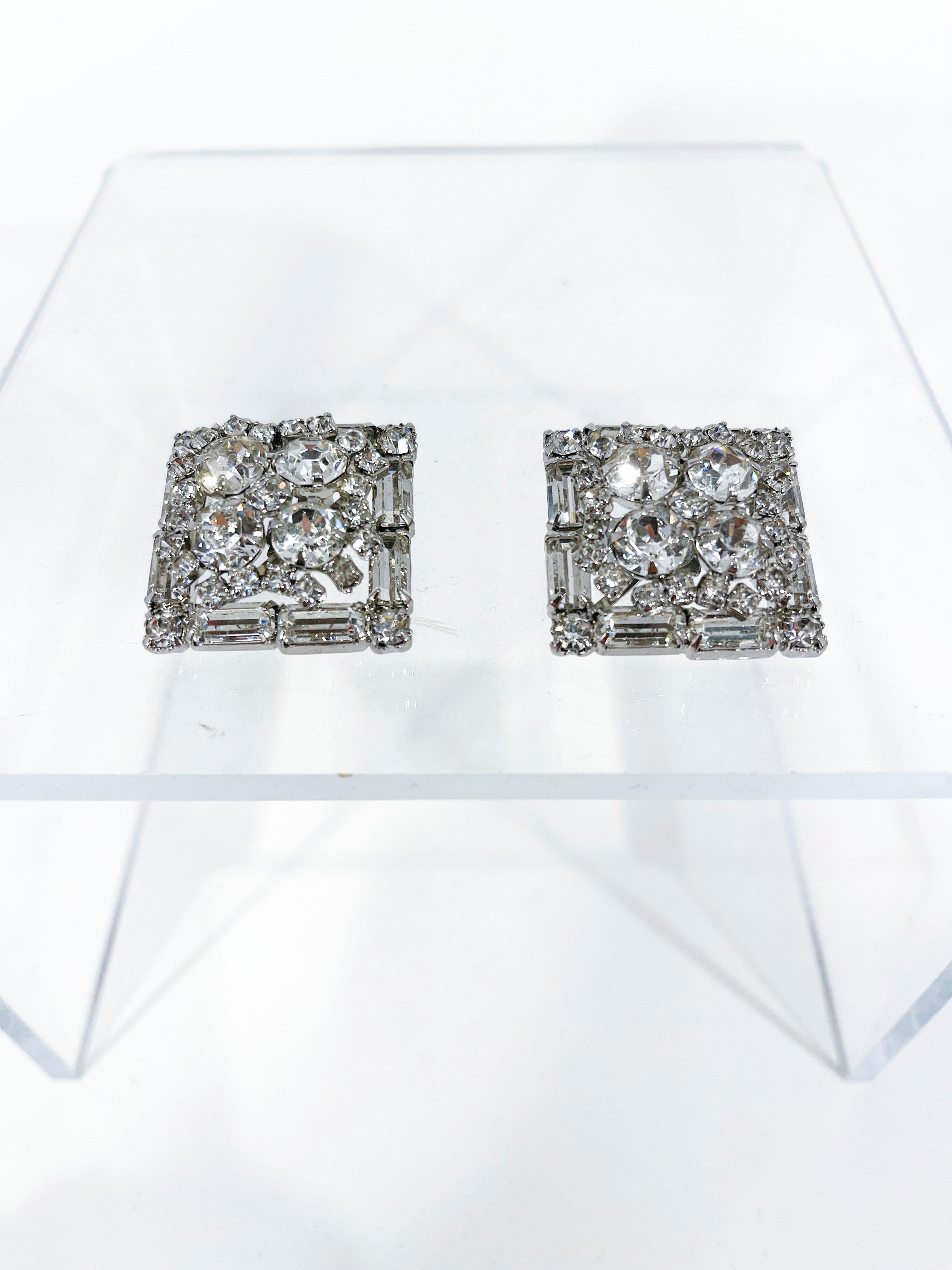 1950's Weiss rhinestone clip-on earrings with multi-cuts of stones in varying sizes. These stones are configured in a square geometric pattern and set in a silver tone.