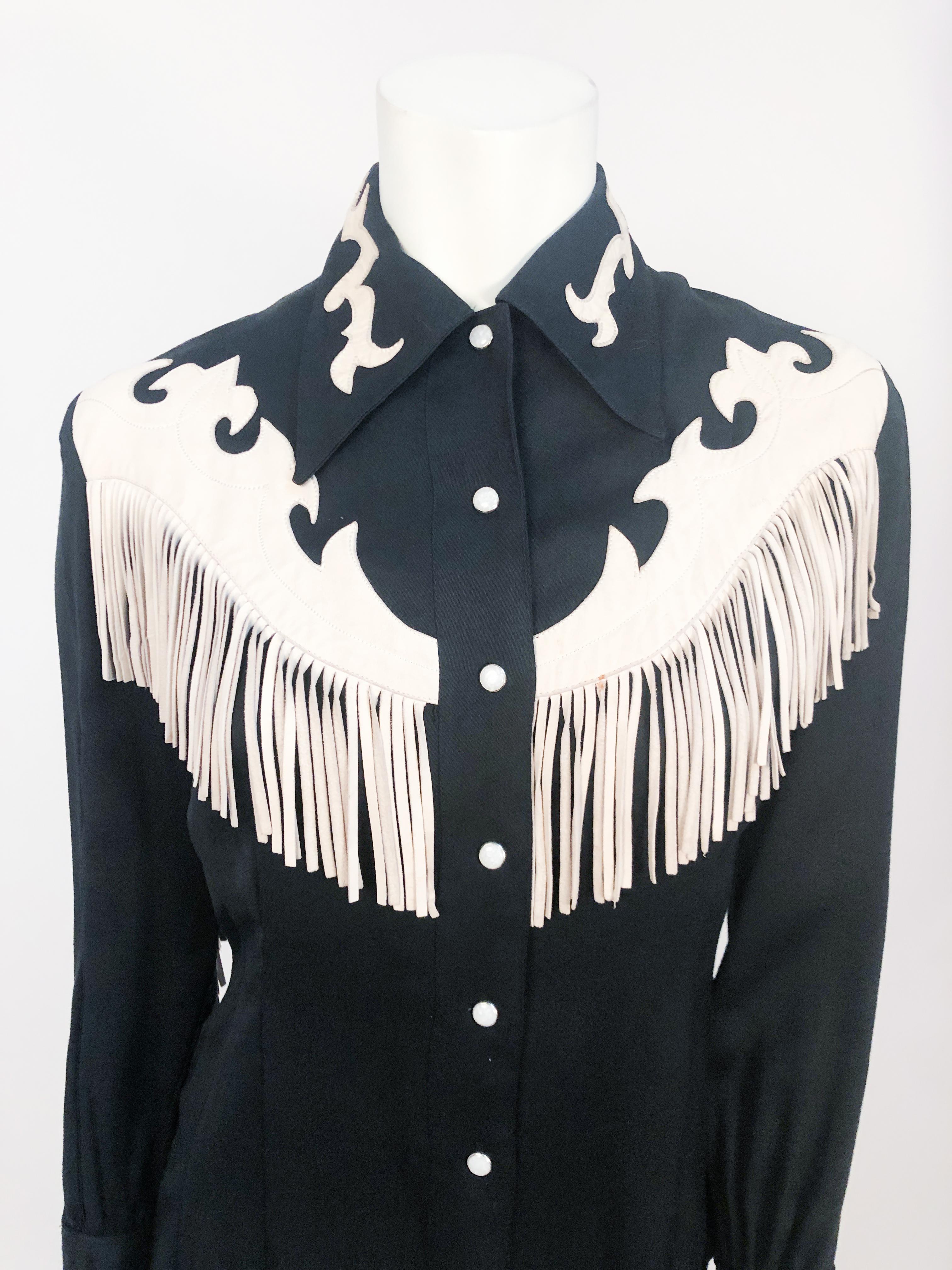 1950s Western Shirt with Cream Leather Appliqué details and Fringe along the sleeves and back. Pearl Snap button closure along the front.