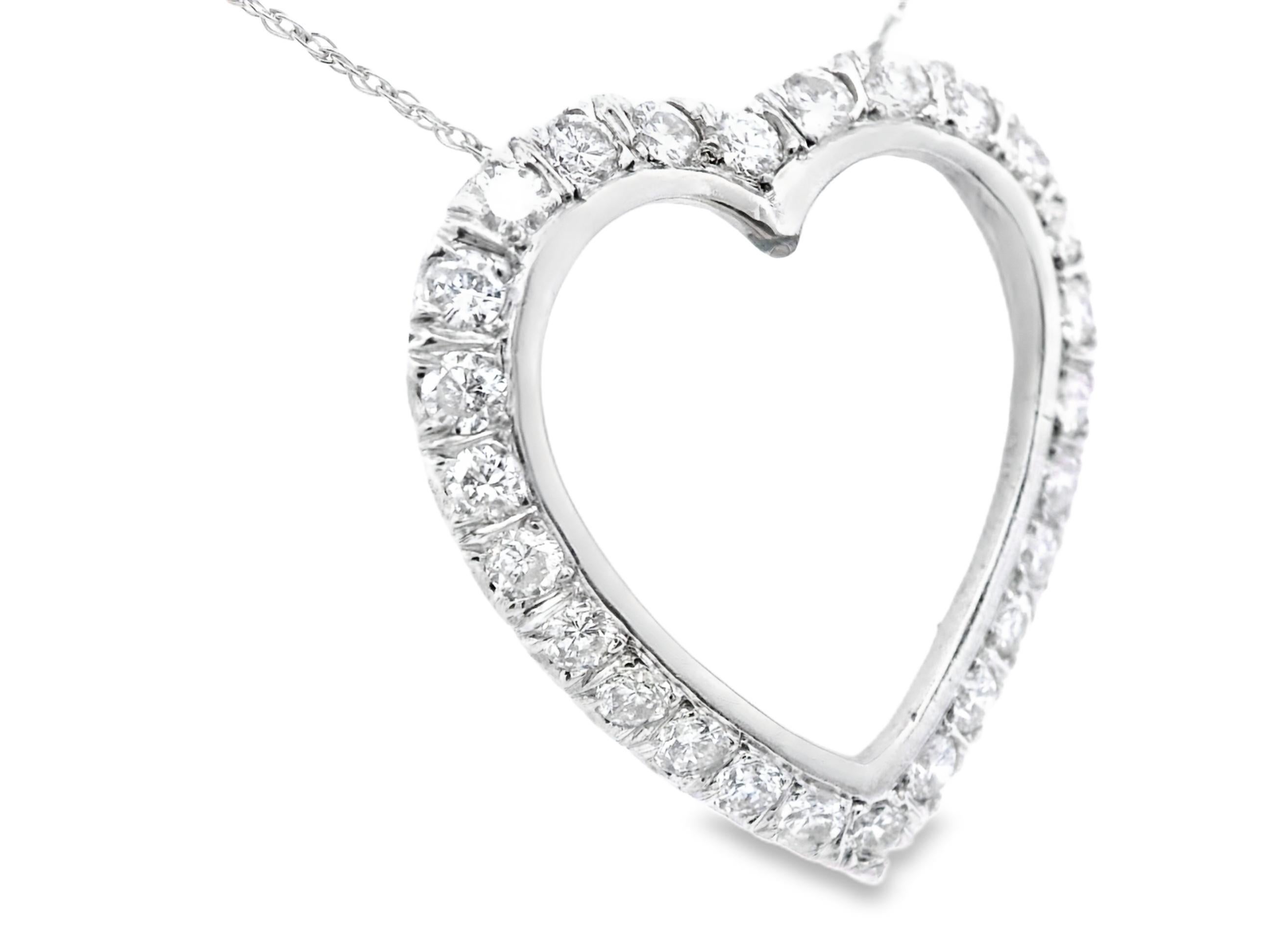 This stunning heart-necklace is made in 14k white gold with bright white diamonds. The necklace showcases 1 carat total of SI1/SI2 clarity, G color diamonds that are bright white and visible from tables away. The pendant slides freely over the