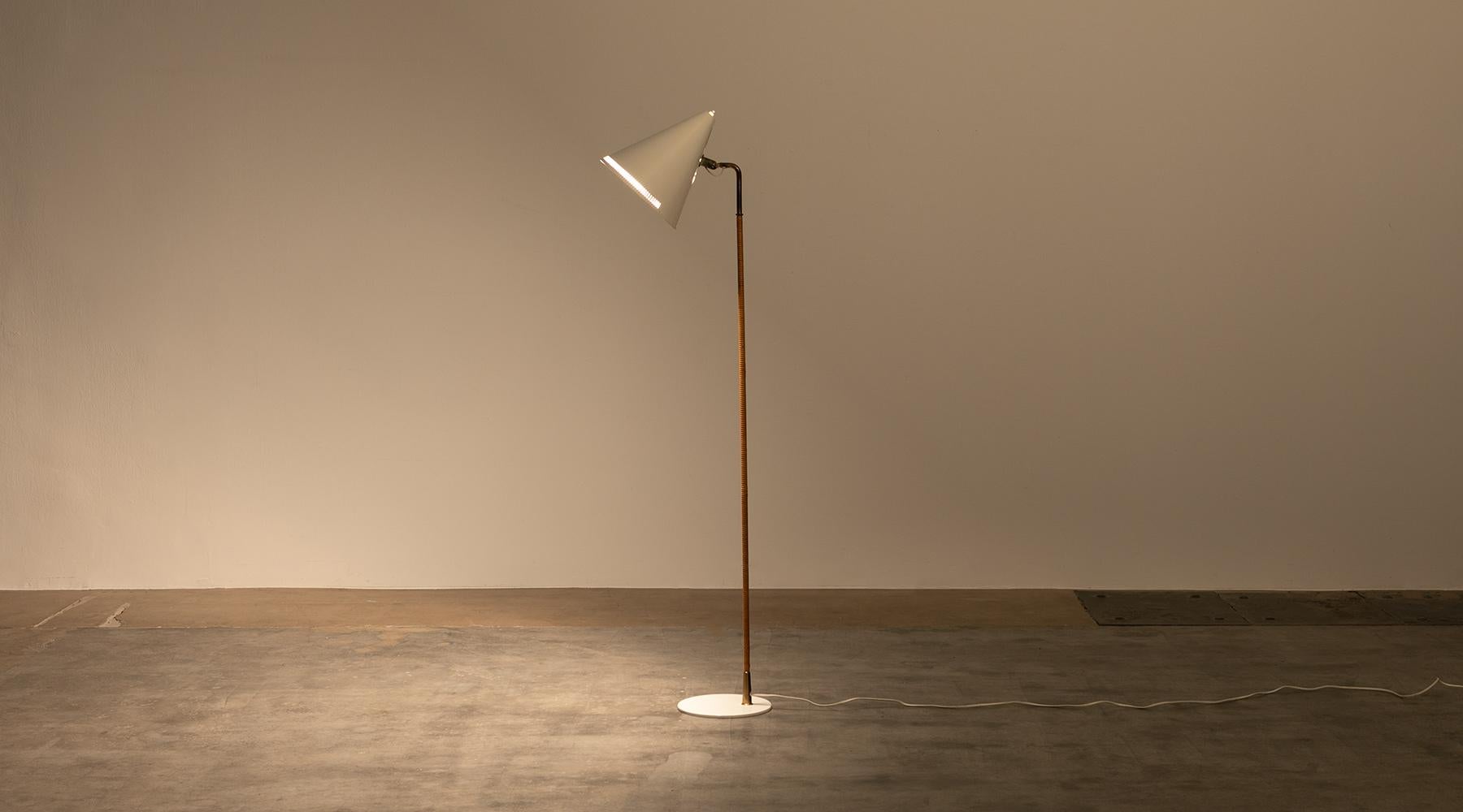 White lacquered and brass and wicker floor lamp by Paavo Tynell, Finland, 1957.

Very elegant floor lamp designed by famous Finnish Paavo Tynell giving a warm charming light. The white lacquered shade is adjustable, the stem is covered in wicker.