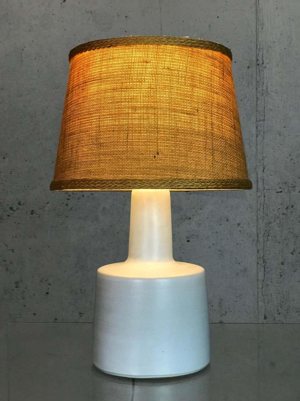 1950s white matte glazed stoneware table lamp by Jane & Gordon Martz for Marshall Studios. Very nice condition. Rewired with a new antique-brass finish socket.
Shade not included - though it takes a shade that clips around the bulb.
(This burlap