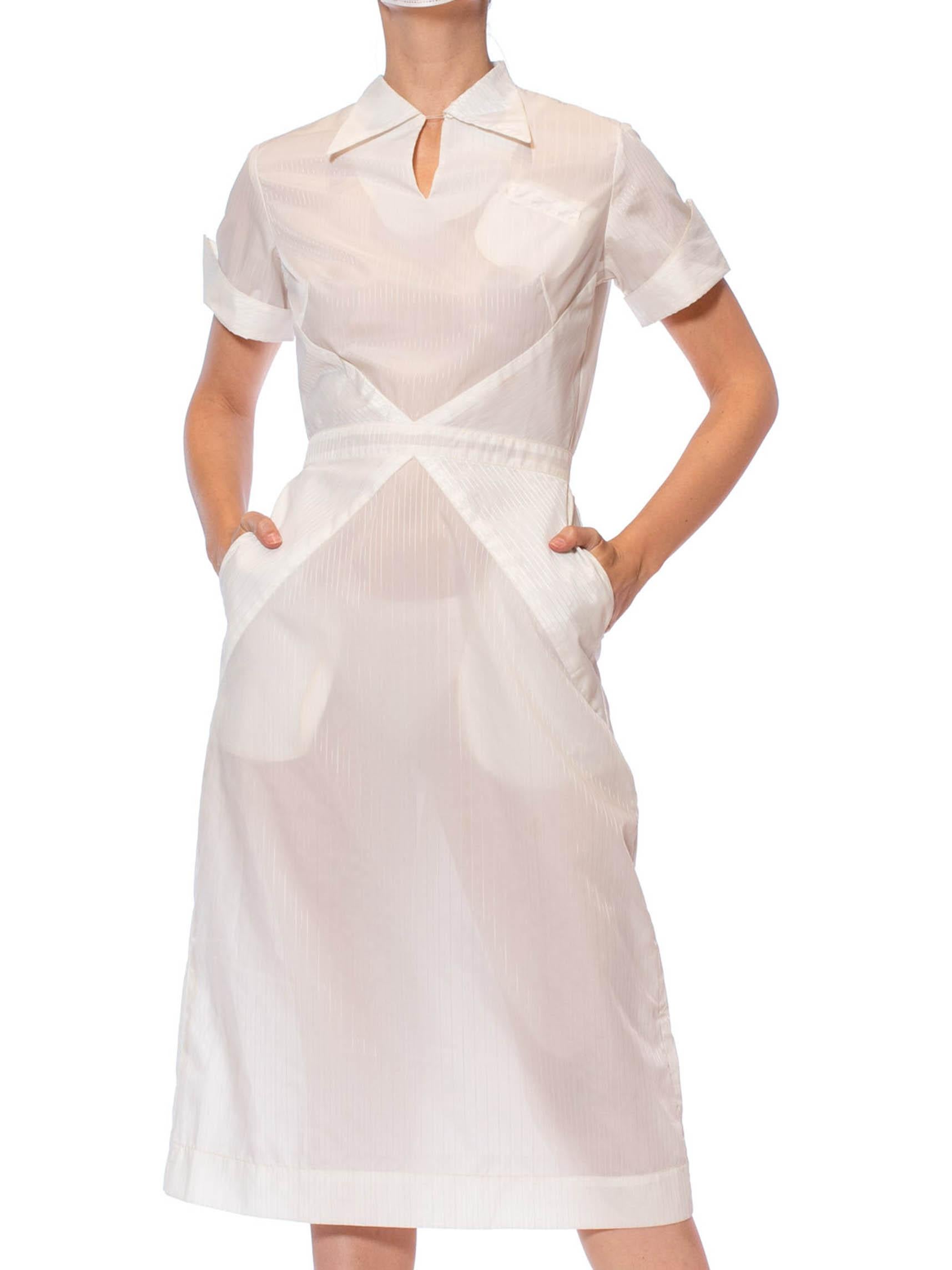1950S White Nylon Pin-Up Nurse Uniform Dress
Decade: 1950s.

Material: Nylon .

Vintage condition: Good.

Measurements
Bust: 37 in.

Waist: 26 in.

Hips: 38 in.

Overall length: 45 in.

US: S.