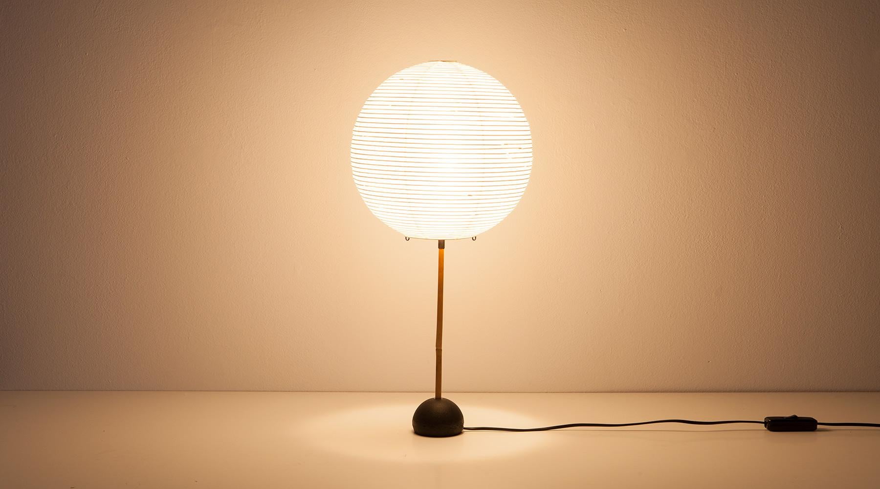 Sculptural light, table lamp by Isamu Noguchi, USA, 1952.

Beautiful table lamp by Isamu Noguchi. The shade is made out of fine paper followed by a bamboo stem ends on a iron base. The lamp promises a very warm, pleasant light. Manufactured by