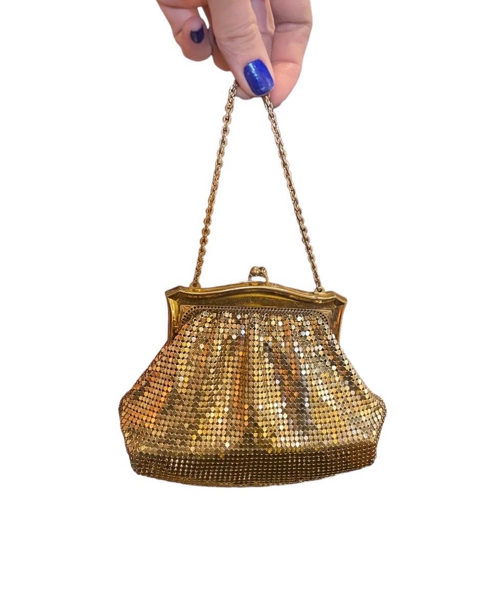 Vintage 1950’s Whiting & Davis Gold Chainmail Mesh Mini Evening Purse with Unique Clasp & Small Chain Strap and Cardboard Beneath the Peach Satin Liner to give the Purse Structure & Shape. 

A Show Stopping Piece of the Time Period. Gorgeous Fun Bag