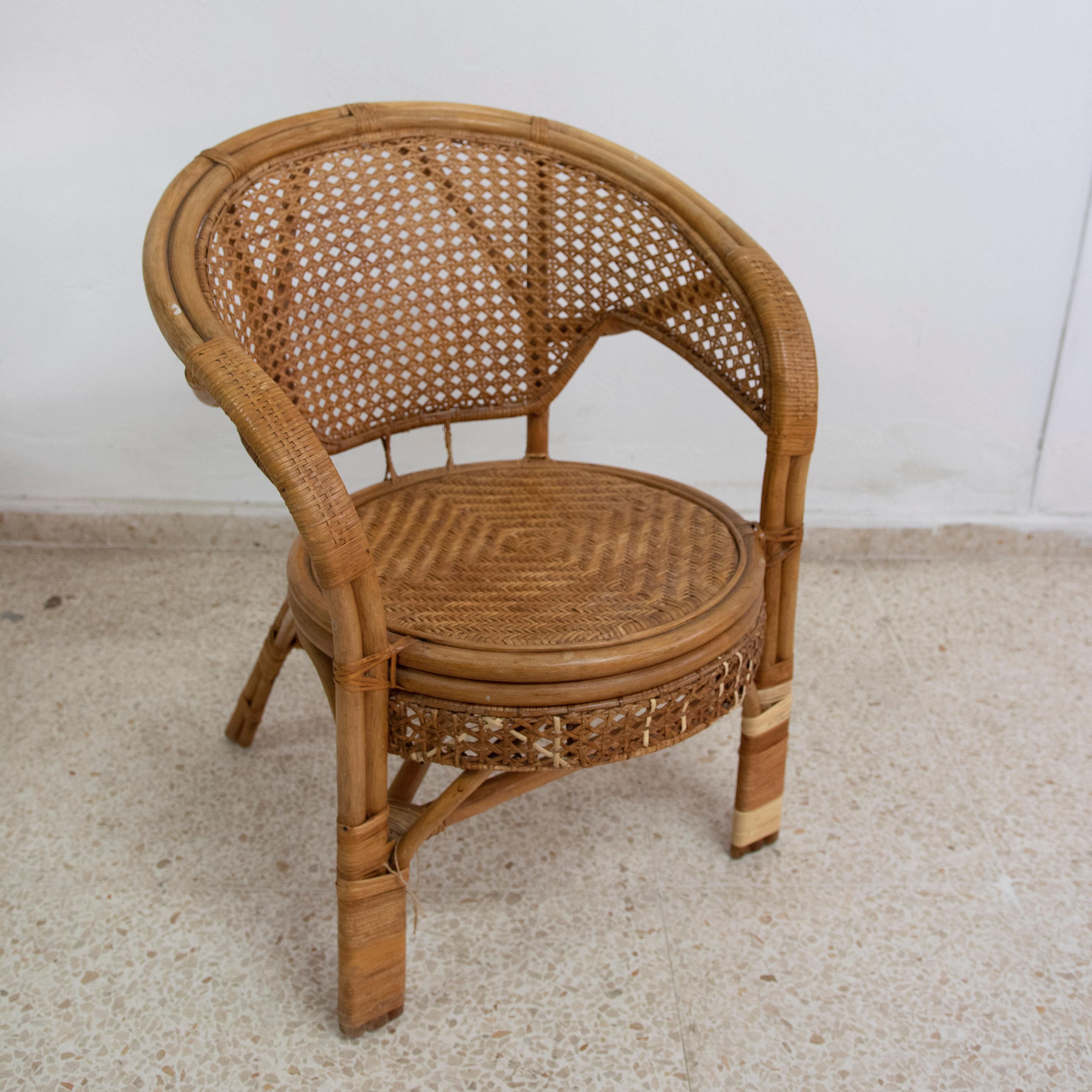 1950s Wicker and bamboo armchair with mesh backrest.