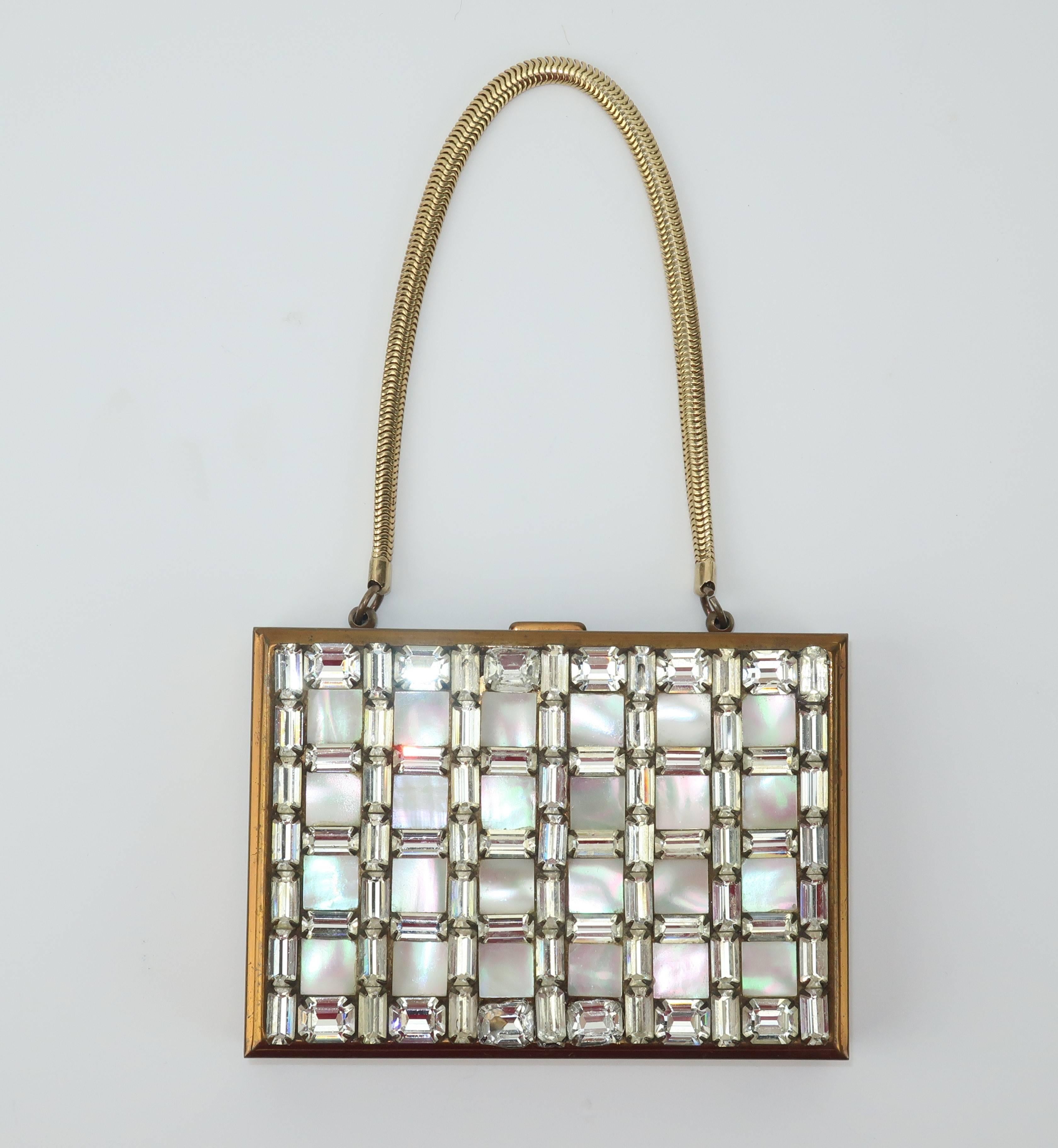Much like chantelaines, elaborate mirrored compacts are feminine gadgets of a bygone era ... and oh so fun to explore! This Wiesner of Miami compact does double duty as a glamorous evening handbag with an embellished rhinestone and mother-of-pearl