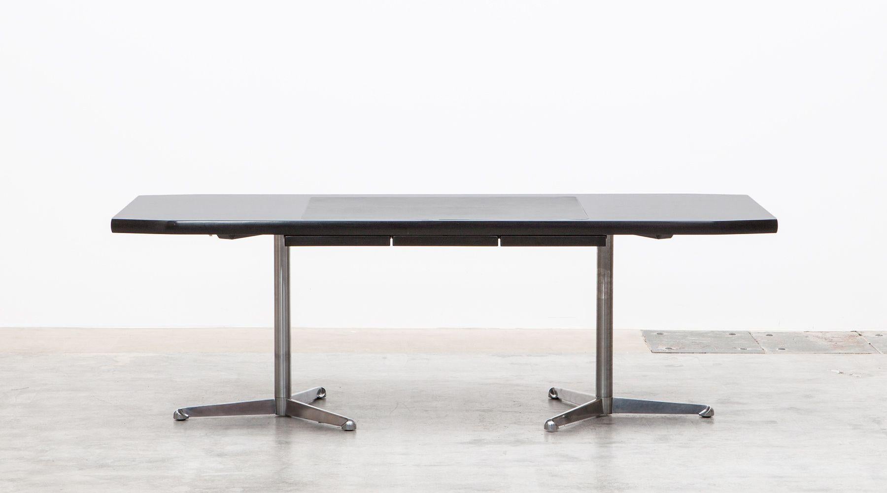 Beautiful Osvaldo Borsani writing desk with a high-quality leather writing surface area. This table is equipped with two chromed tubular steel tripod feet which is a great contrast to the dark wooden top which contains in the middle section three
