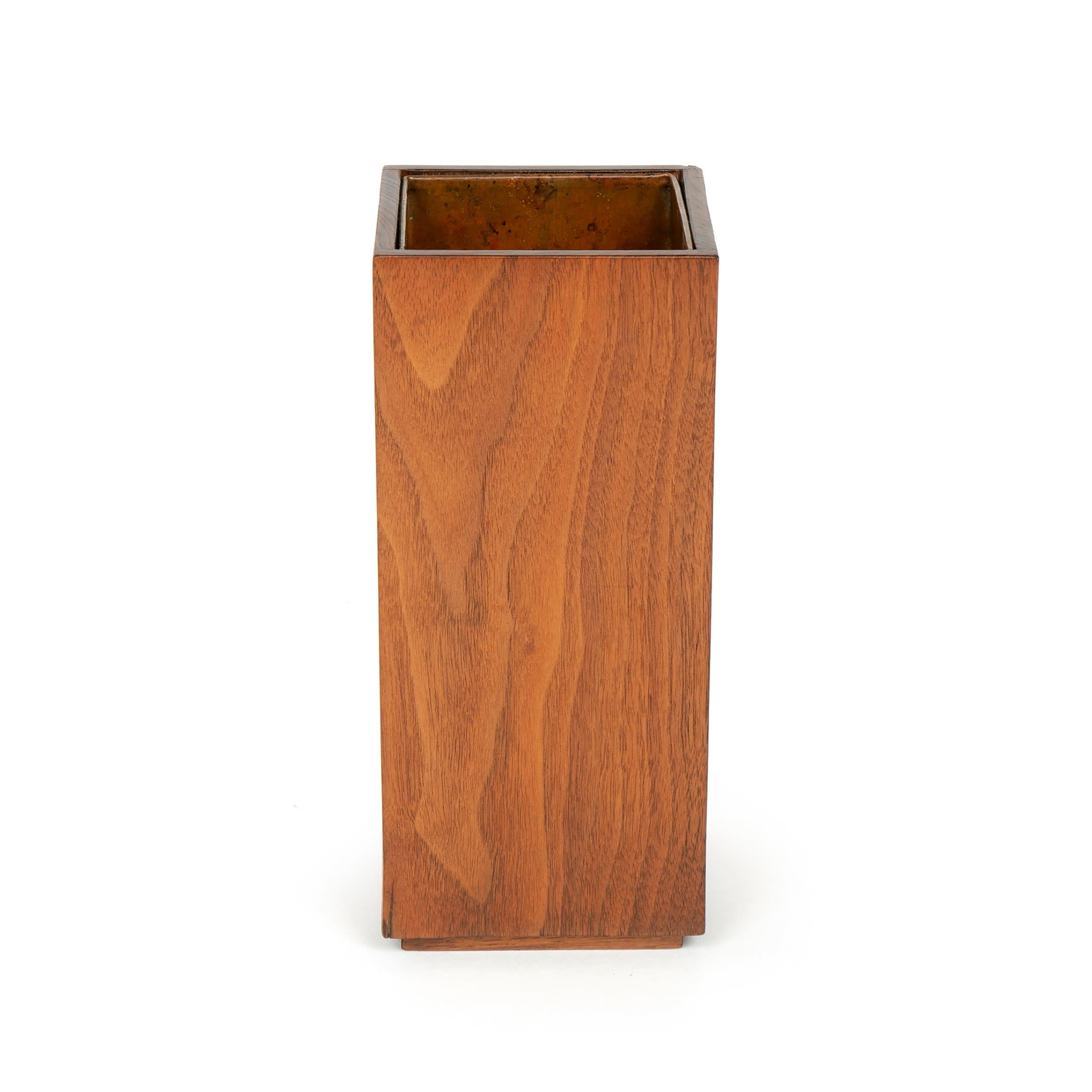 A copper lined rectilinear walnut planter / vase, on a small plinth base.