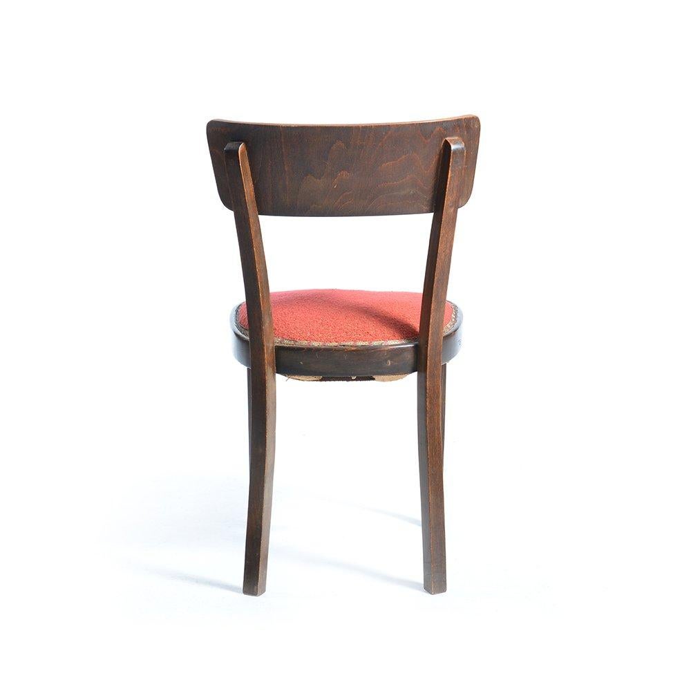 Strong chair dates back to the 1950s. Very good, original condition. Made of wood with upholstered seat. The seat is with springs which are original and still in very good condition. Small signs of age visible on the upholstery and wood.