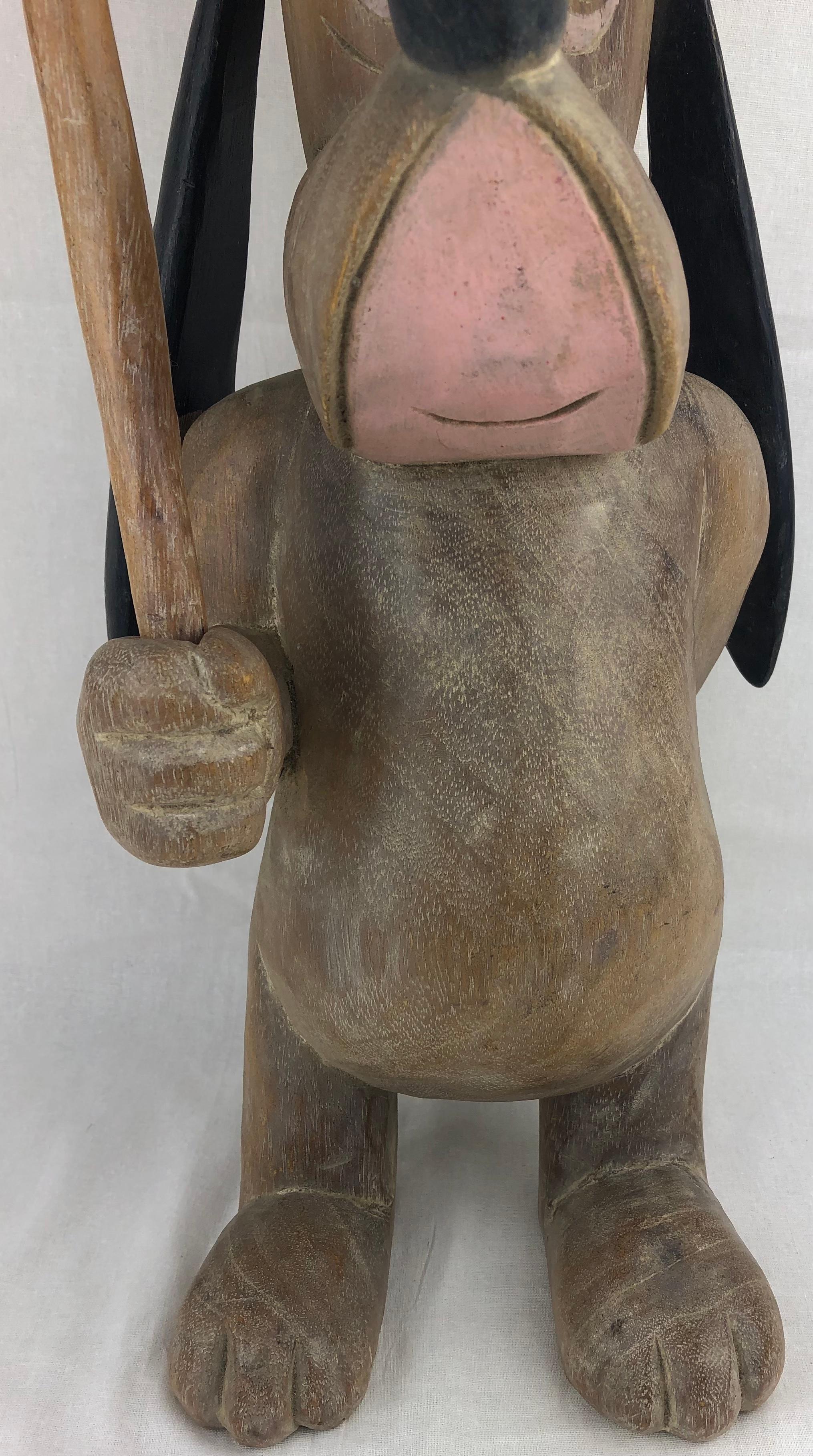 A playful hand-carved and hand-painted wooden sculpture of the Disney dog character, Droopy, holding a sign I'm So Happy. A rare collectable of wood carving circa 1950, unique beauty and fun of this unusual wood Americana.

Measures: 18