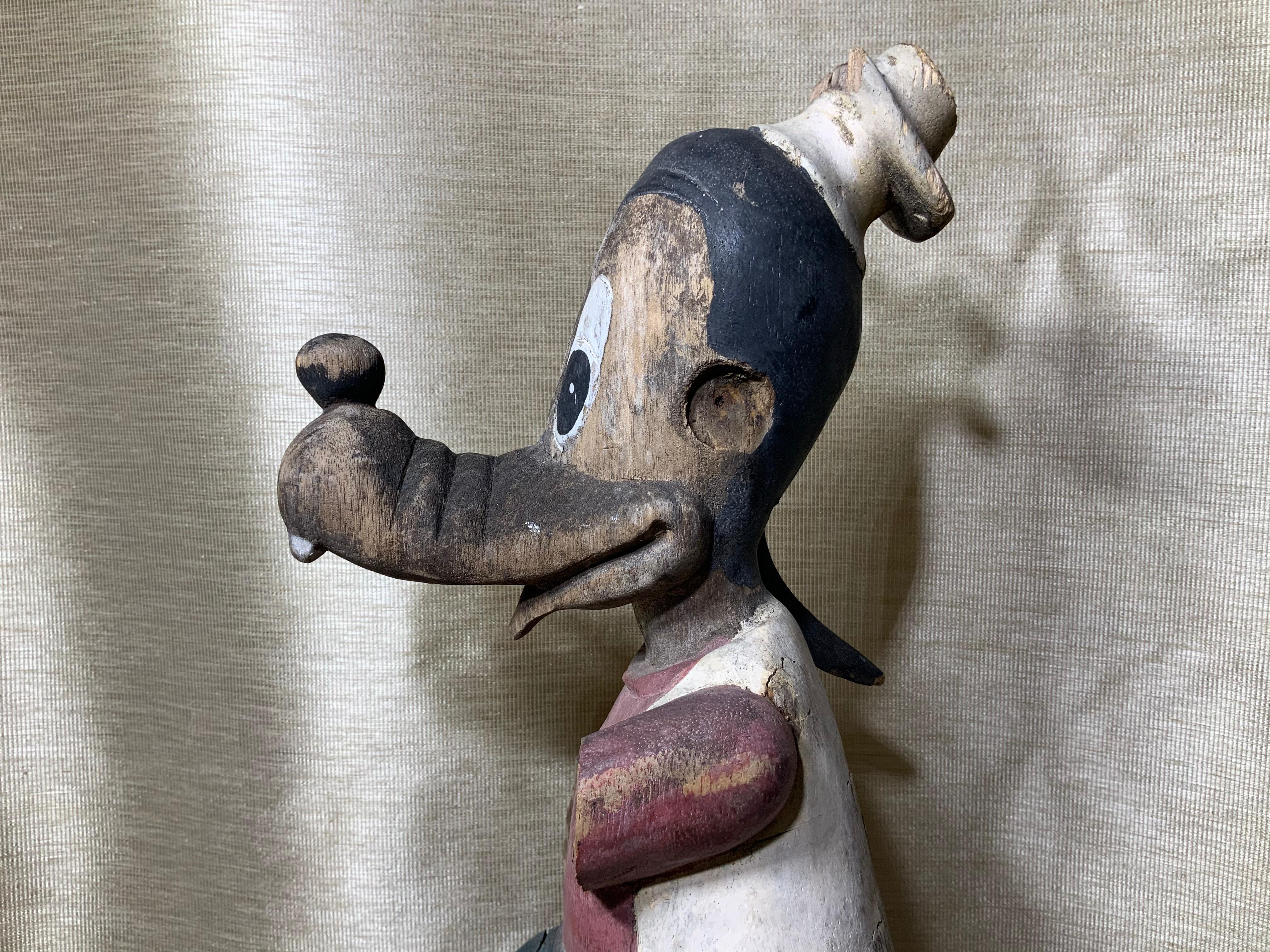 A rare collectable of wood carving circa 1950 very desirable Disney’s character of goofy hand painted, this is sold as it, it is missing one ear part of the guitar, fart of the foot parts of two hand, but still keep the unique beauty and fun of this