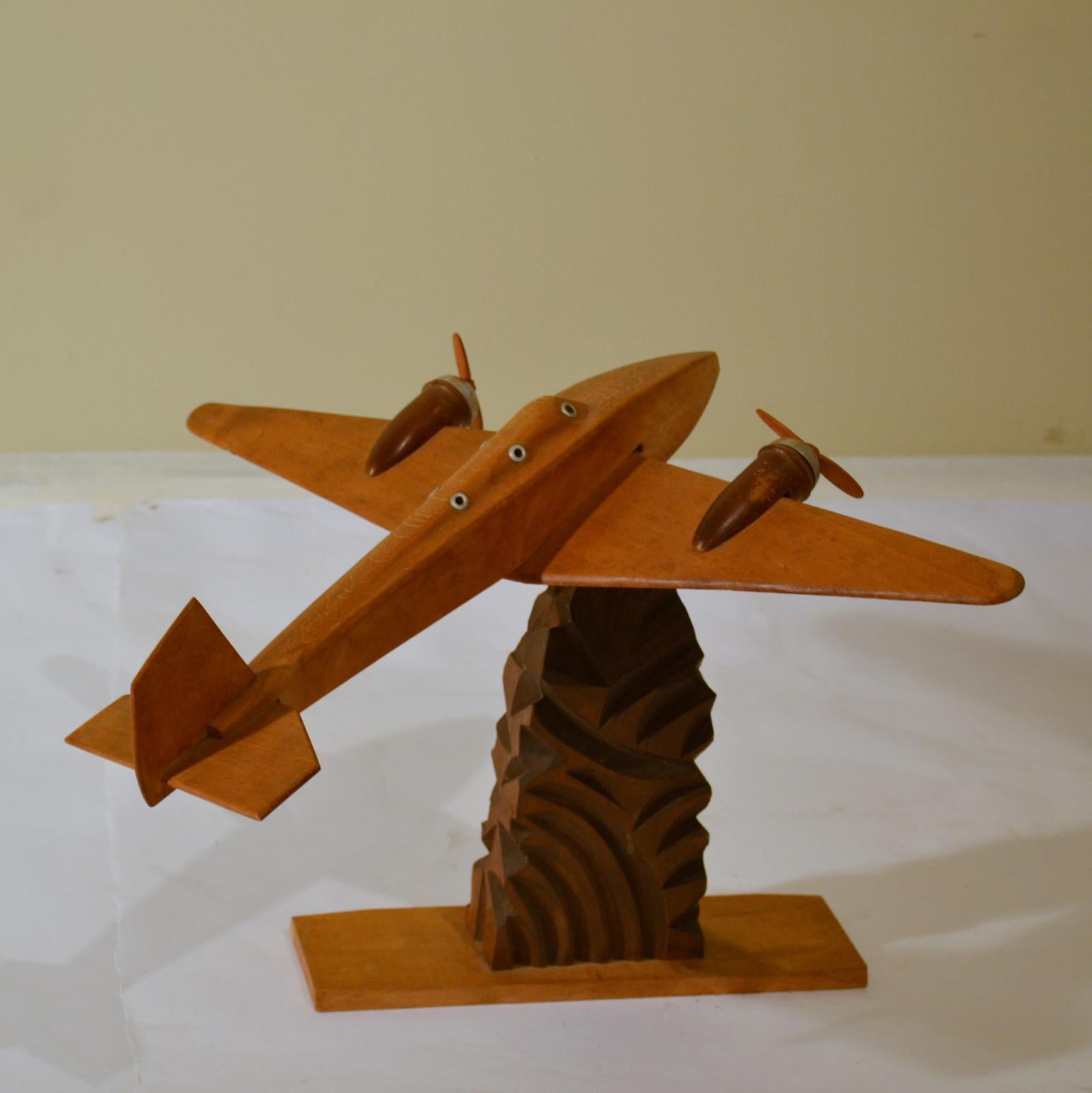Airplane model carved in wood, circa 1940s-1950s. Decorative sculpture that displays well cupboard, credenza or a desk.