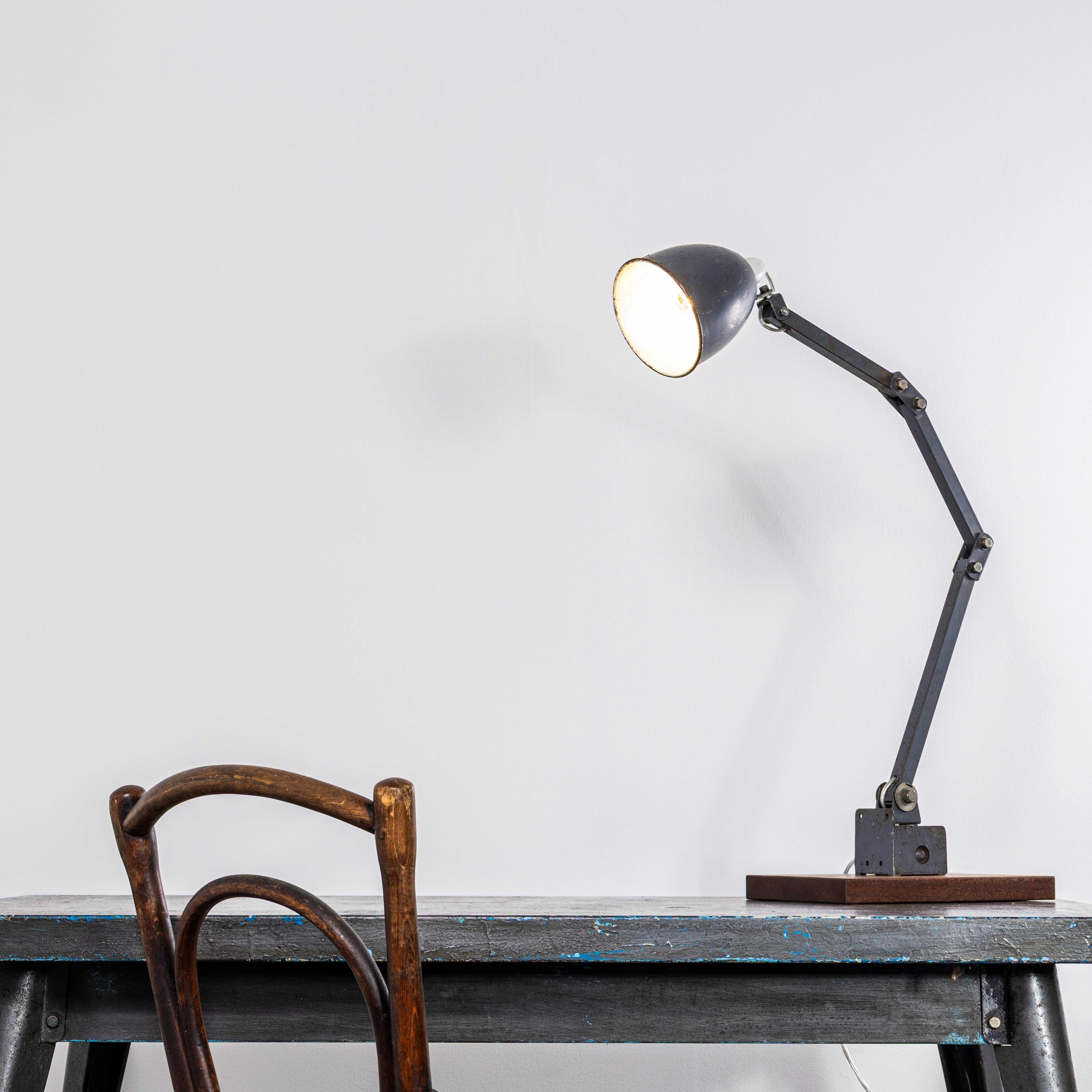 1950’s Workshop Task Lamp By Memlite. 
The lamp was produced by Memlite, the company was founded in 1908 originally to produce electrical switches and components. The lamp has been cleaned and restored but we have left the history and character. The