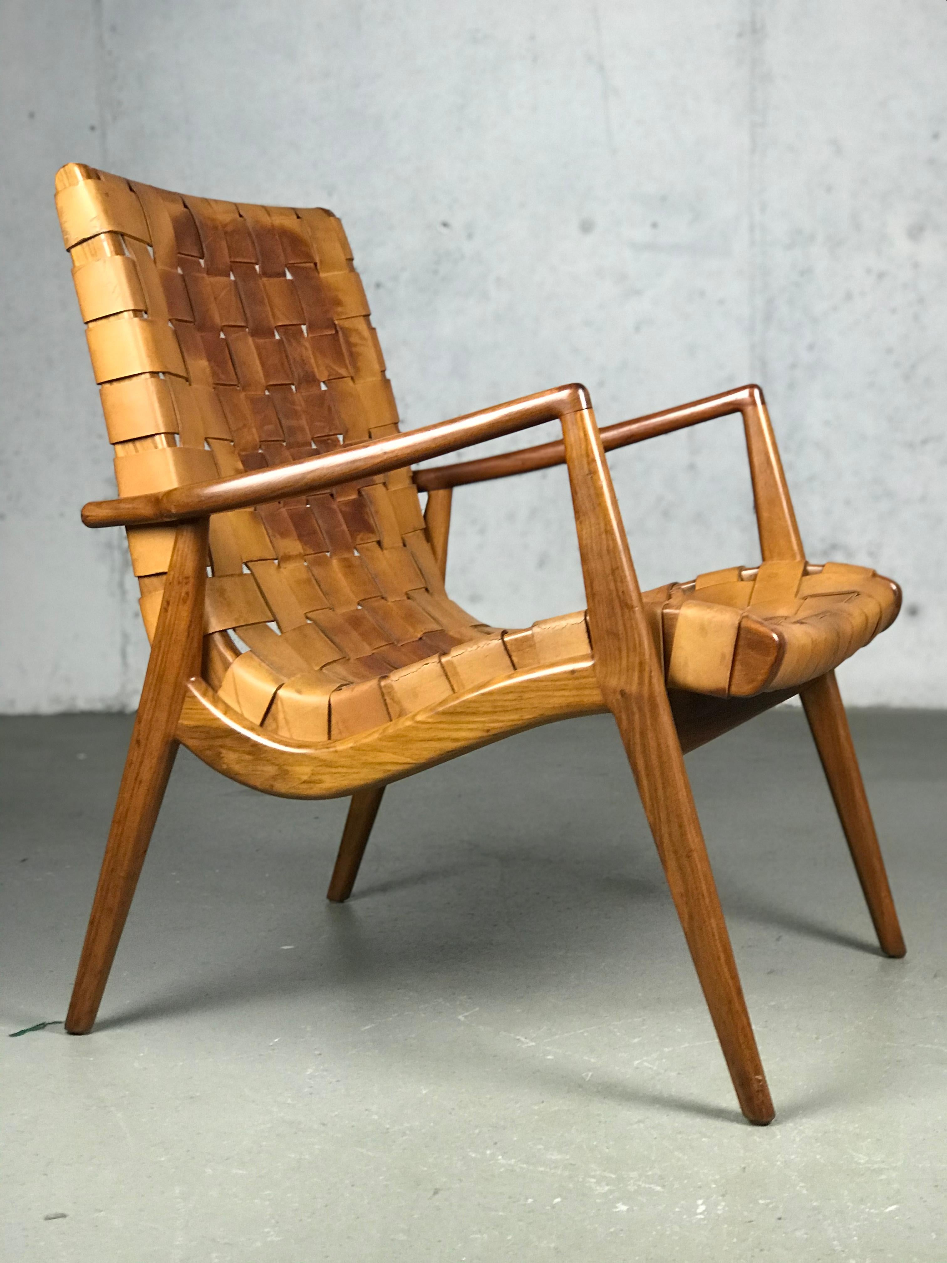 A beautiful and original woven leather lounge chair and ottoman by Mel Smilow, 1956. The original leather has plenty of patina and the walnut graining is impressive. The wood has not been refinished and the leather has one strap broken at the edge