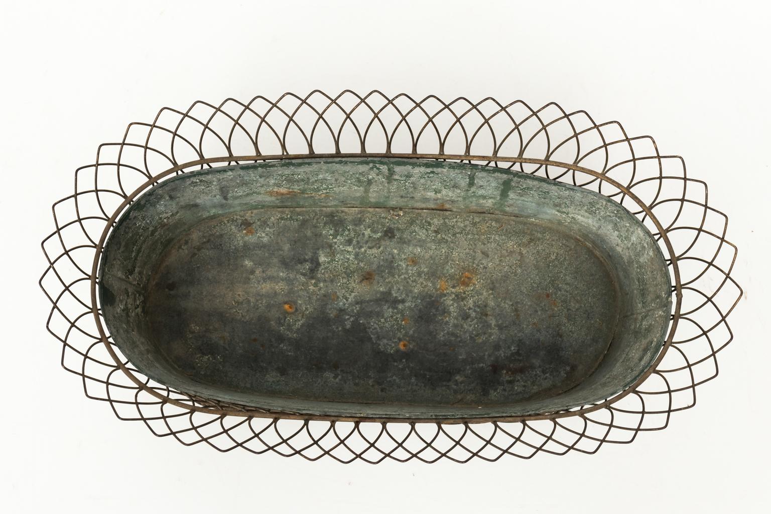 1950s woven wire decorative basket with black painted tole cachepot.
 