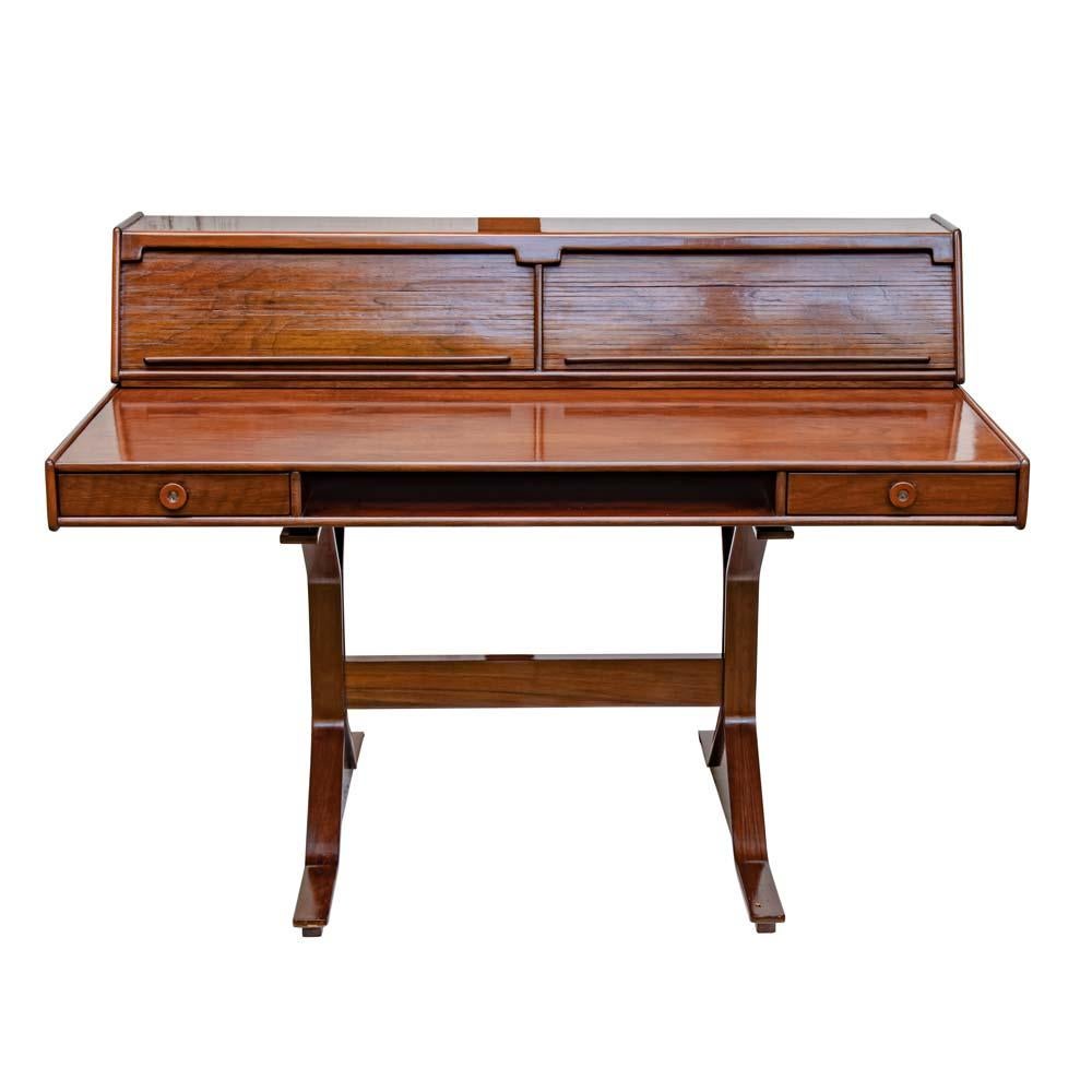 A beautiful 1950s modernist rosewood desk. Italian design by Giancarlo Frattini for Bernini 
This desk in a warm shade of light brown has two drawers and a top storage with two tambour doors it is very sturdy, well built and very confortable.
The