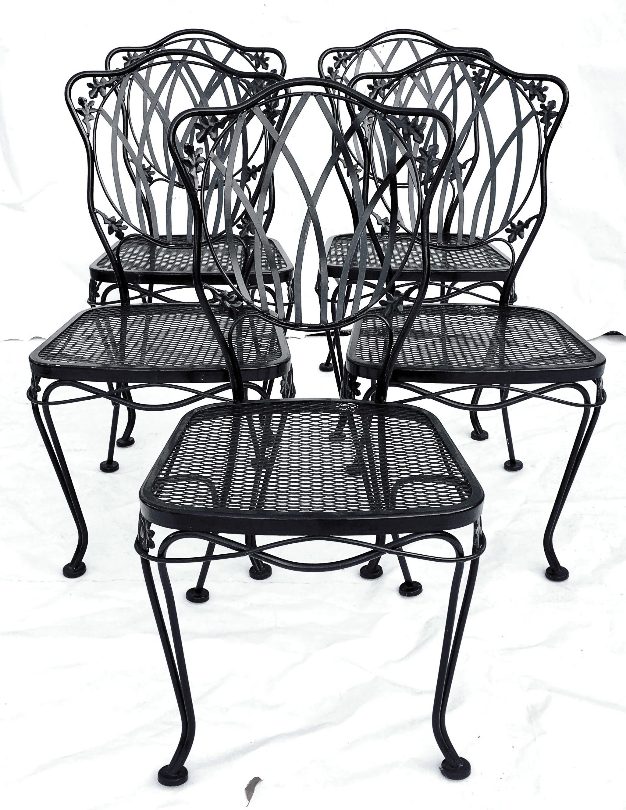 Mid-Century Black Wrought Iron floral & vine motif metal mesh chairs by, Russell Woodard.Features the original black painted indoor outdoor treated finish. Includes the original and detachable seat cushions. Original manufactures tag present on