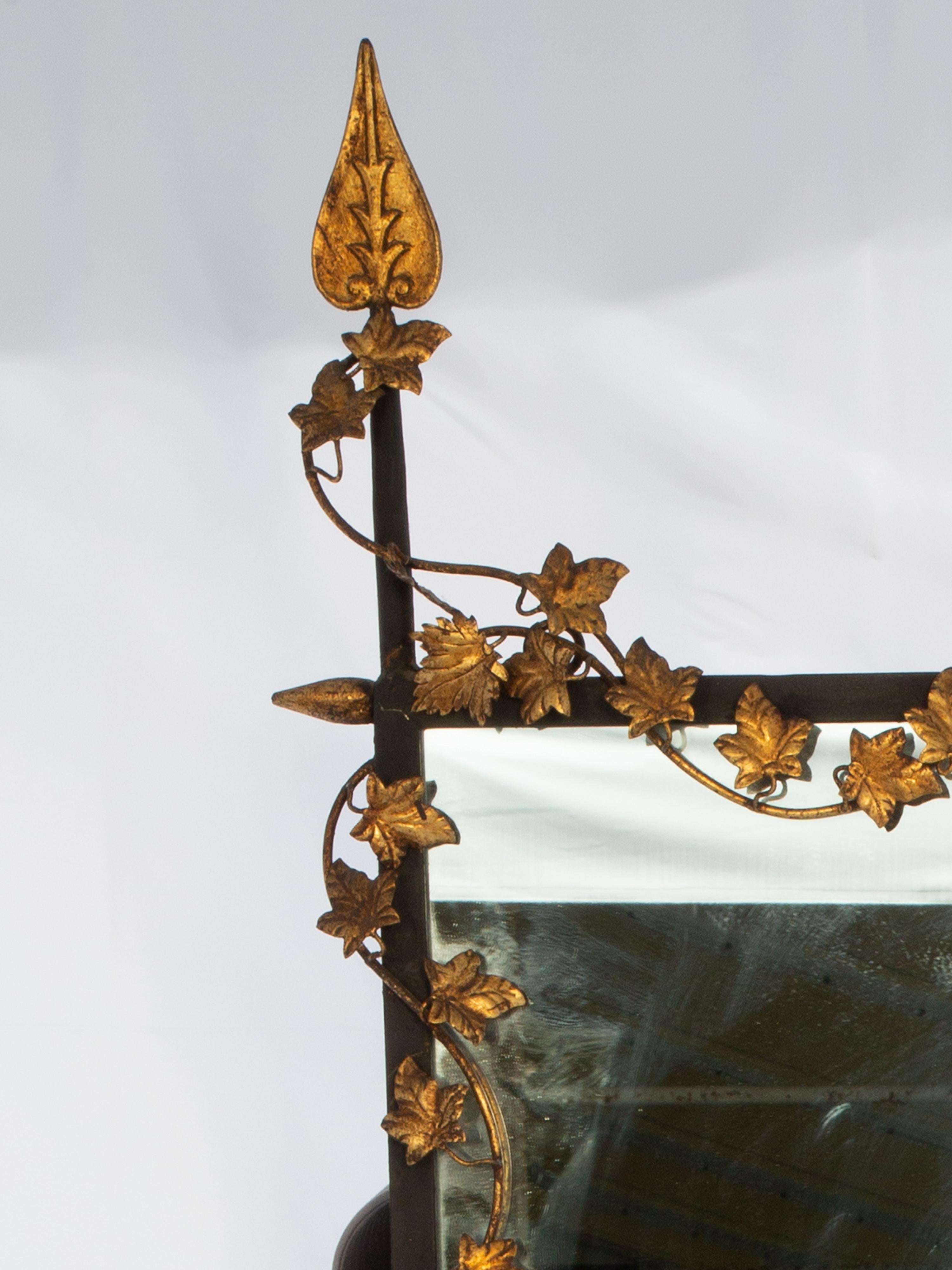 Vintage wall mirror, of wrought iron, by Palladio. Its rectangular frame wrapped in gilded foliate vines, surmounted by an H-pediment flanked by spade finials. 

Please contact us for alternative shipping quotes.

Stock ID: D4111