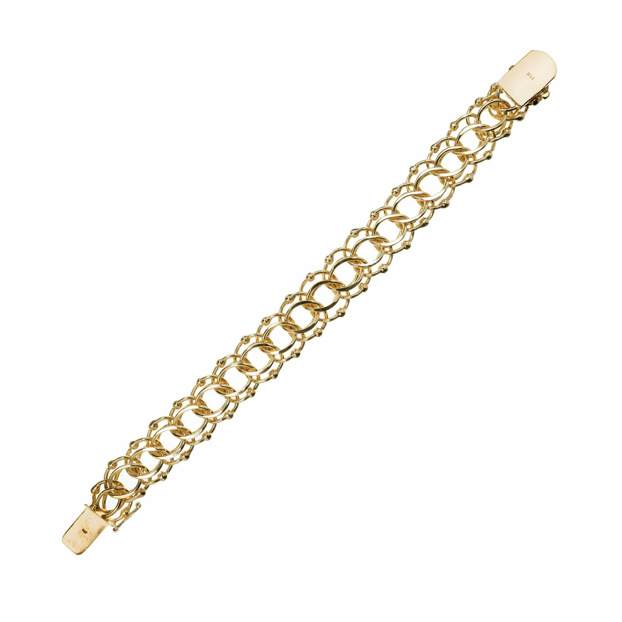 Vintage 1950's heavy double spiral link 14k yellow gold bracelet, beaded spiral design. Designed for multiple charms of varying sizes. 7.5 inches in length. 

14k yellow gold
Tested and stamped: 14k
47.6 grams
Length: 7.5 inches
Width: