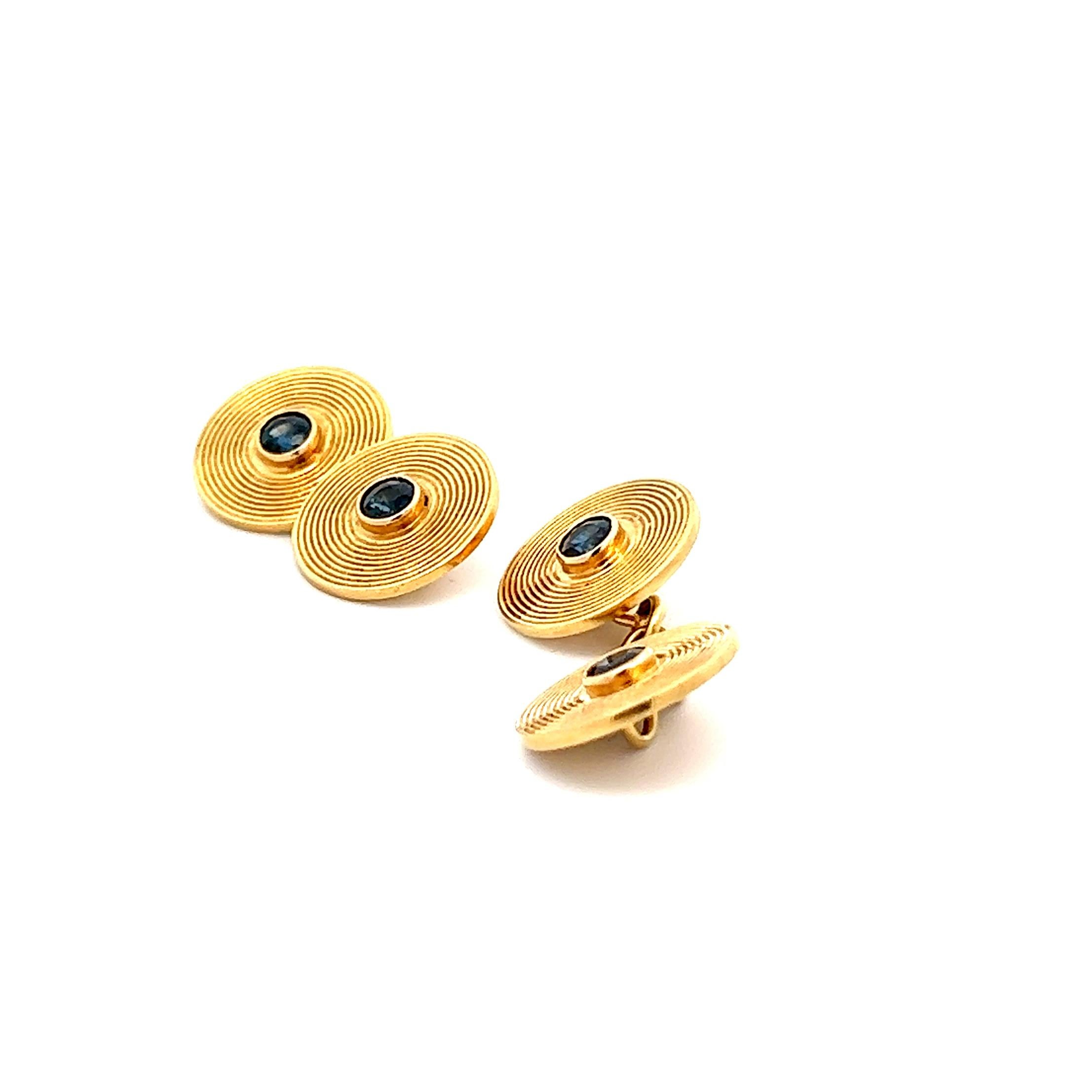 This is a fantastic pair of French Cartier sapphire cufflinks made in 18k yellow gold from the 1950s. The cufflinks are signed Cartier and have the correct marks for the time. There are four, 1.20 total weight round cut sapphires, one in each button