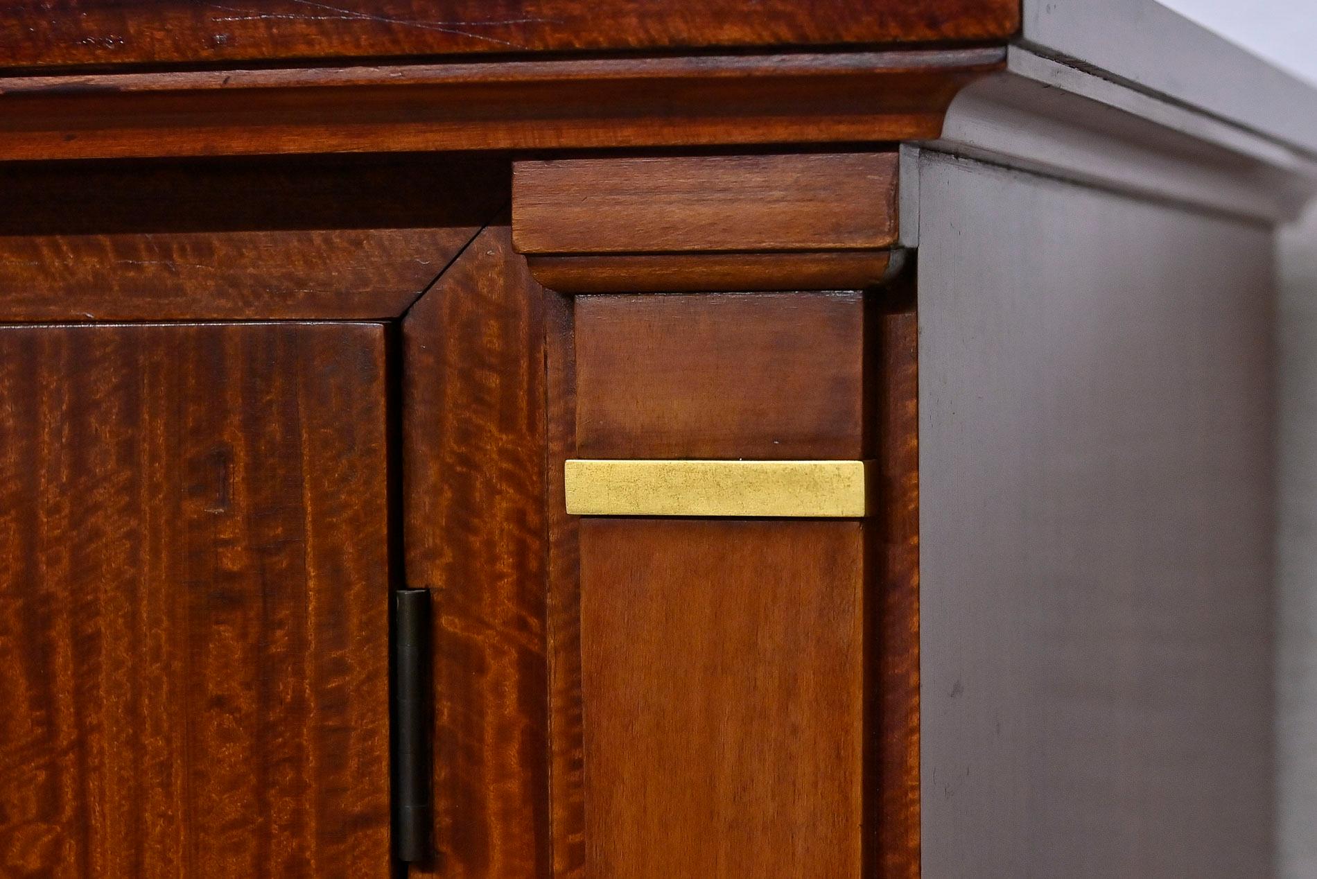 This particularly unusual and classic-style french sideboard from the 1950s blends in with any stylish interior with its simple elegance. The warm brown tone of the high-quality mahogany veneer shines on the outside, while the surprising brightness