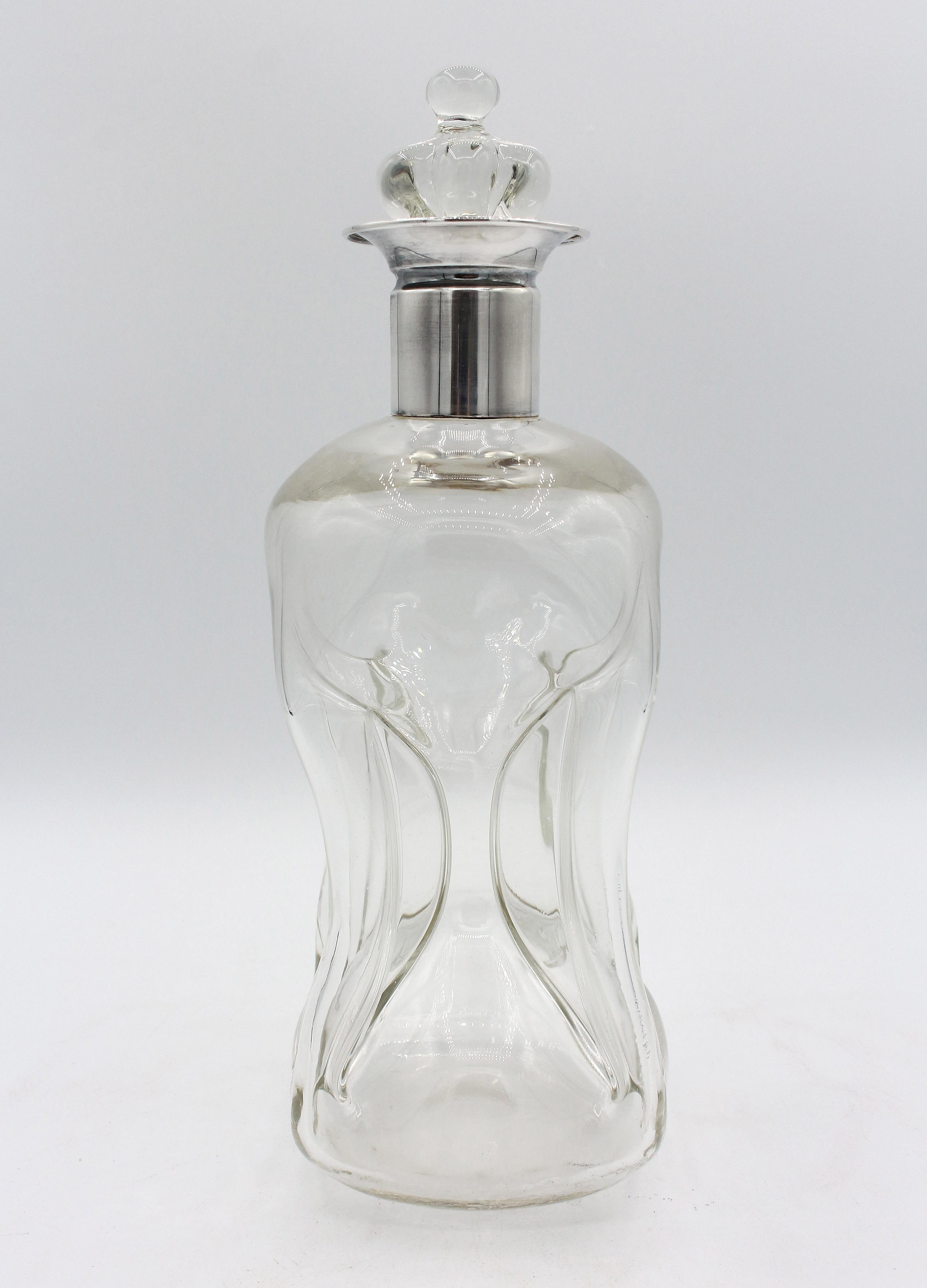 1951 Danish blown glass & silver Kluk Kluk decanter. Original crown stopper. Made by E. Dragsted, silver collar with his hallmark. The name comes from the pouring sound due to the pinched sections form. Chip inner edge of decanter. Slight residue