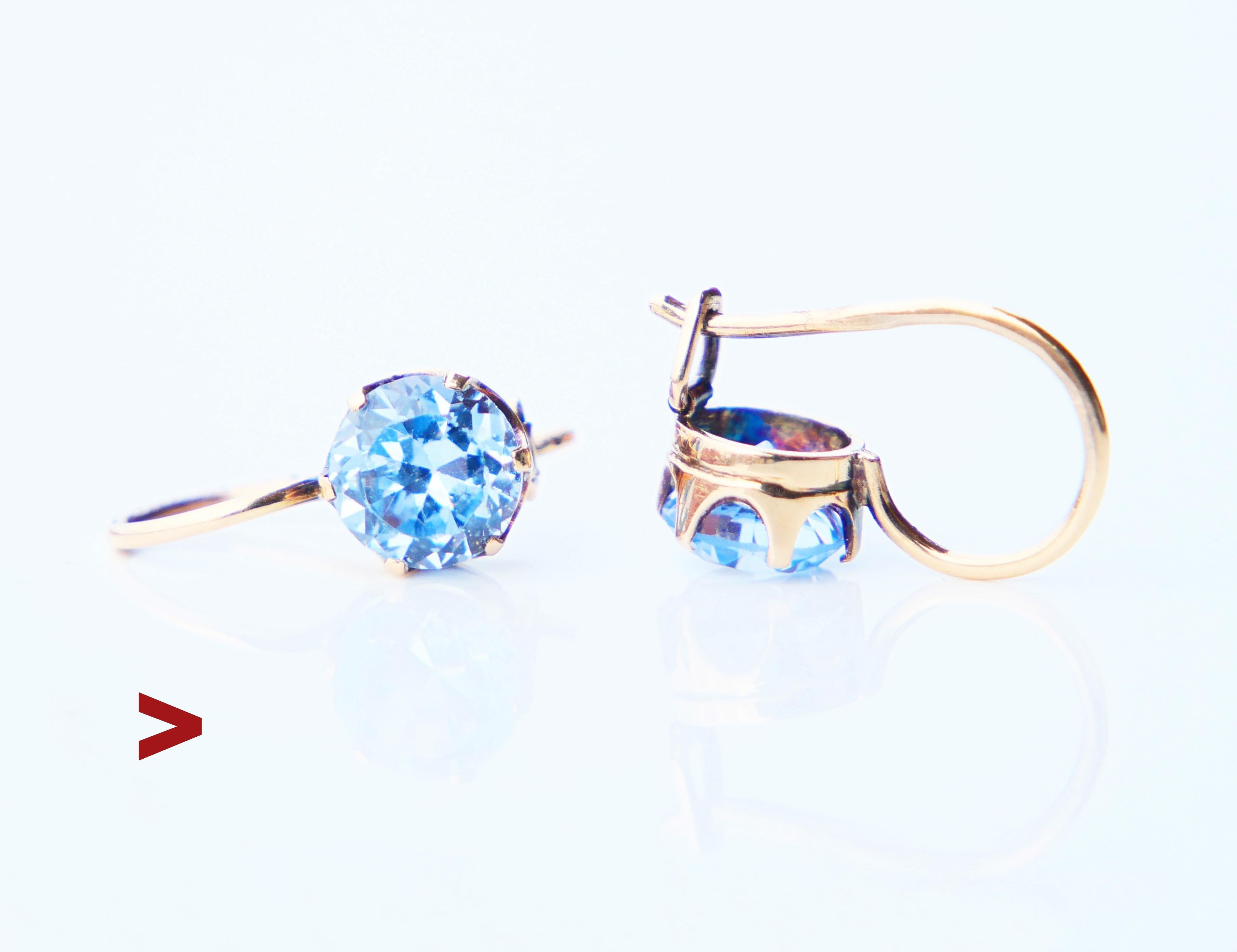 A pair of Vintage Finish 14K Rose Gold Earrings with claw set diamond cut Blue Spinel stones. Stones are likely lab made and imitate valuable Natural light blue Spinels very closely.

Made in Finland, both wires hallmarked 585 for 14K Rose Gold.