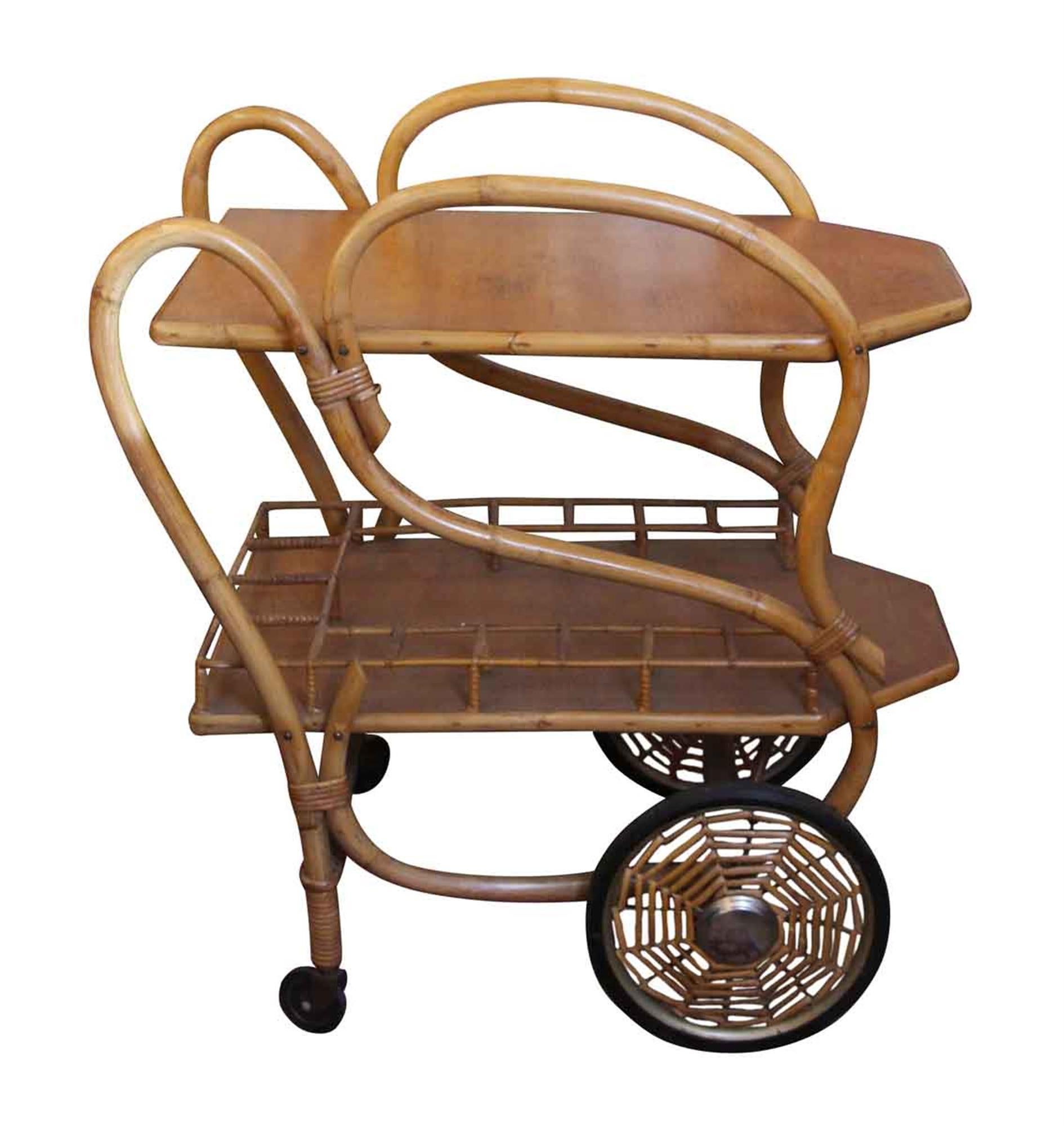 This rare 1951 Mid-Century Modern bamboo tea cart is labeled The Halle Bros. Company and dated 1951. It is in very good condition. The spider web wheels make it truly unique! This can be seen at our 2420 Broadway location on the upper west side in