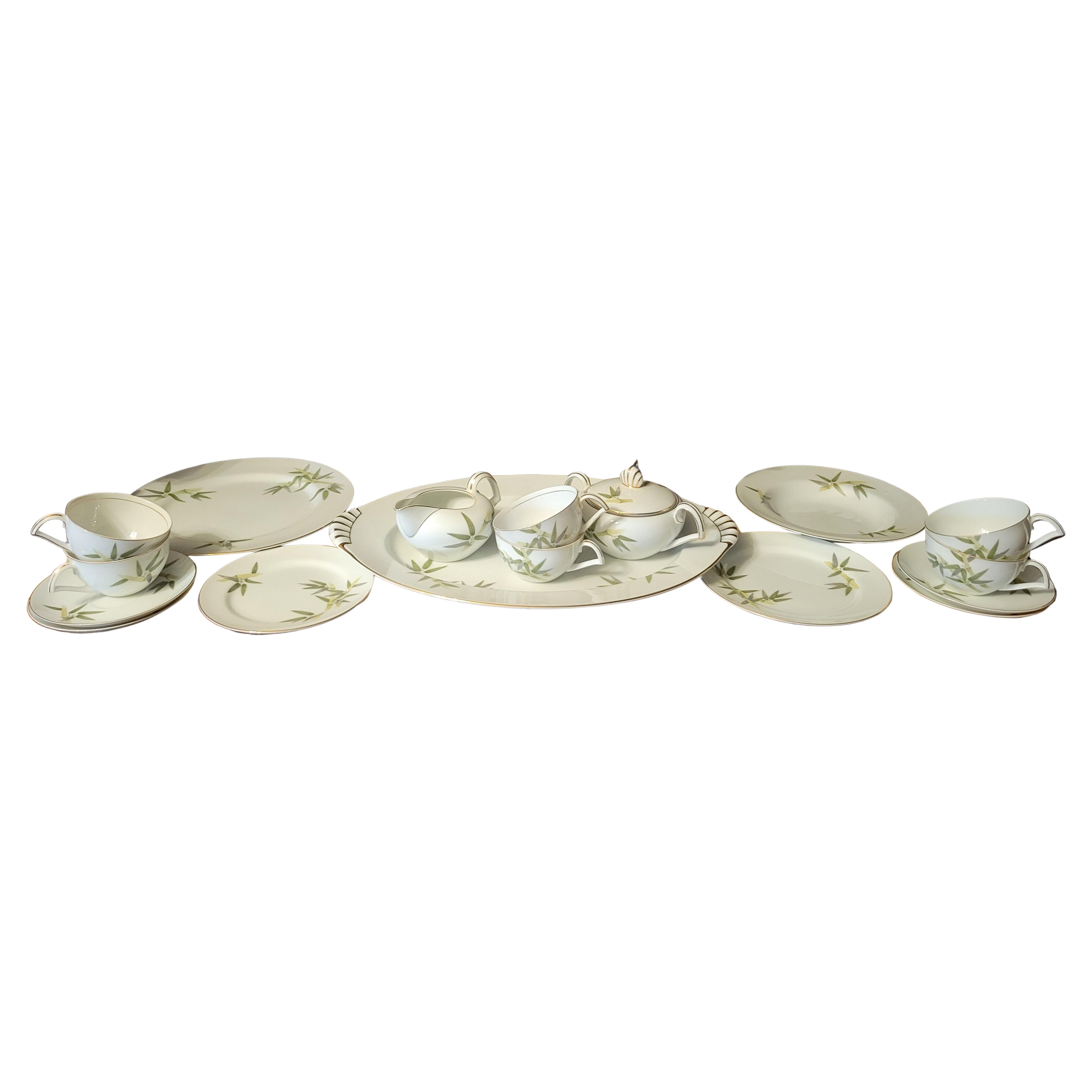 1951 Narumi Japan fine porcelain set in a 'Spring Bamboo' pattern.
The set consists of 52 pieces:
(8) tea cups - 4 cups have gold trip inside of cups, 4 cups don't. 
(8) saucers
(8) bread & butter plates - 6.5