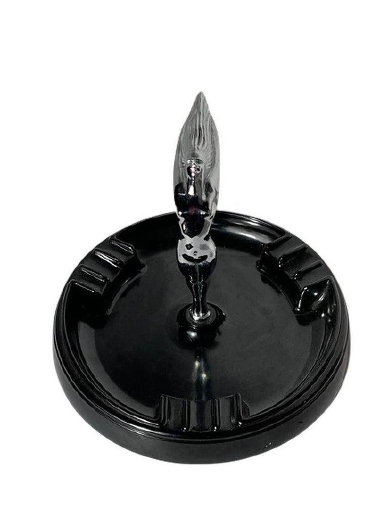 This Chicago-manufactured ashtray from 1952 is a fine piece for the Tobacco connoisseur. The tray is made from Bakelite and the goddess figure is chrome. The goddess is reminiscent of hood ornaments from classic cars of the 30s. She's situated