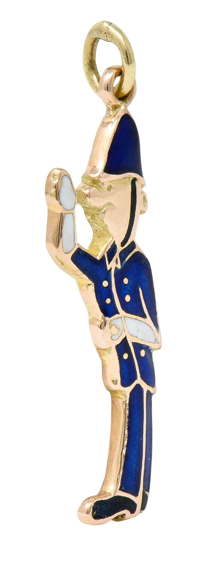Designed as a British Bobby style police officer

Featuring a domed hat and uniform glossed with bright ultramarine blue enamel

With additional black and white enamel details

Exhibiting no loss

Maker's mark and British hallmarks for 9 karat gold,
