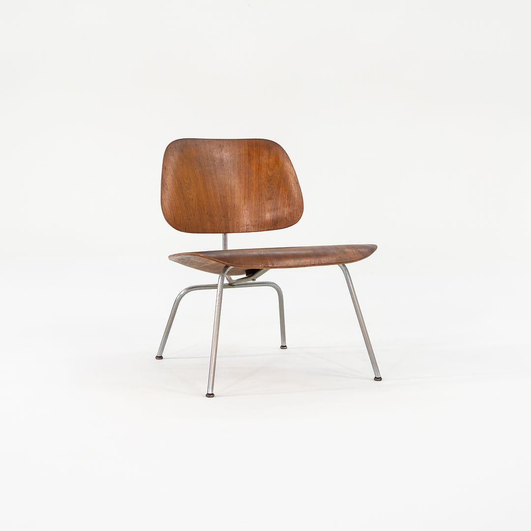 This is an Eames Molded Plywood Lounge Chair with a Metal Base, or an LCM Chair, initially designed by Charles and Ray Eames in 1946. This particular piece was produced by Herman Miller in the USA in 1952. It features a molded five-ply bent wood