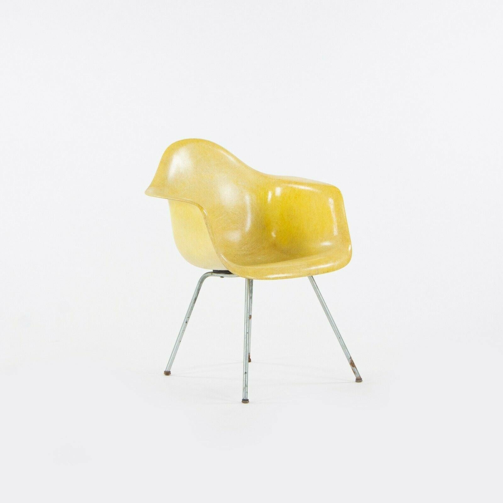 Listed for sale is a super rare and original set of four lemon yellow Herman Miller Eames fiberglass dining / side chairs, designed by Ray and Charles Eames. These chairs are the SAX standard chairs, which sit slightly lower than the DAX (slightly