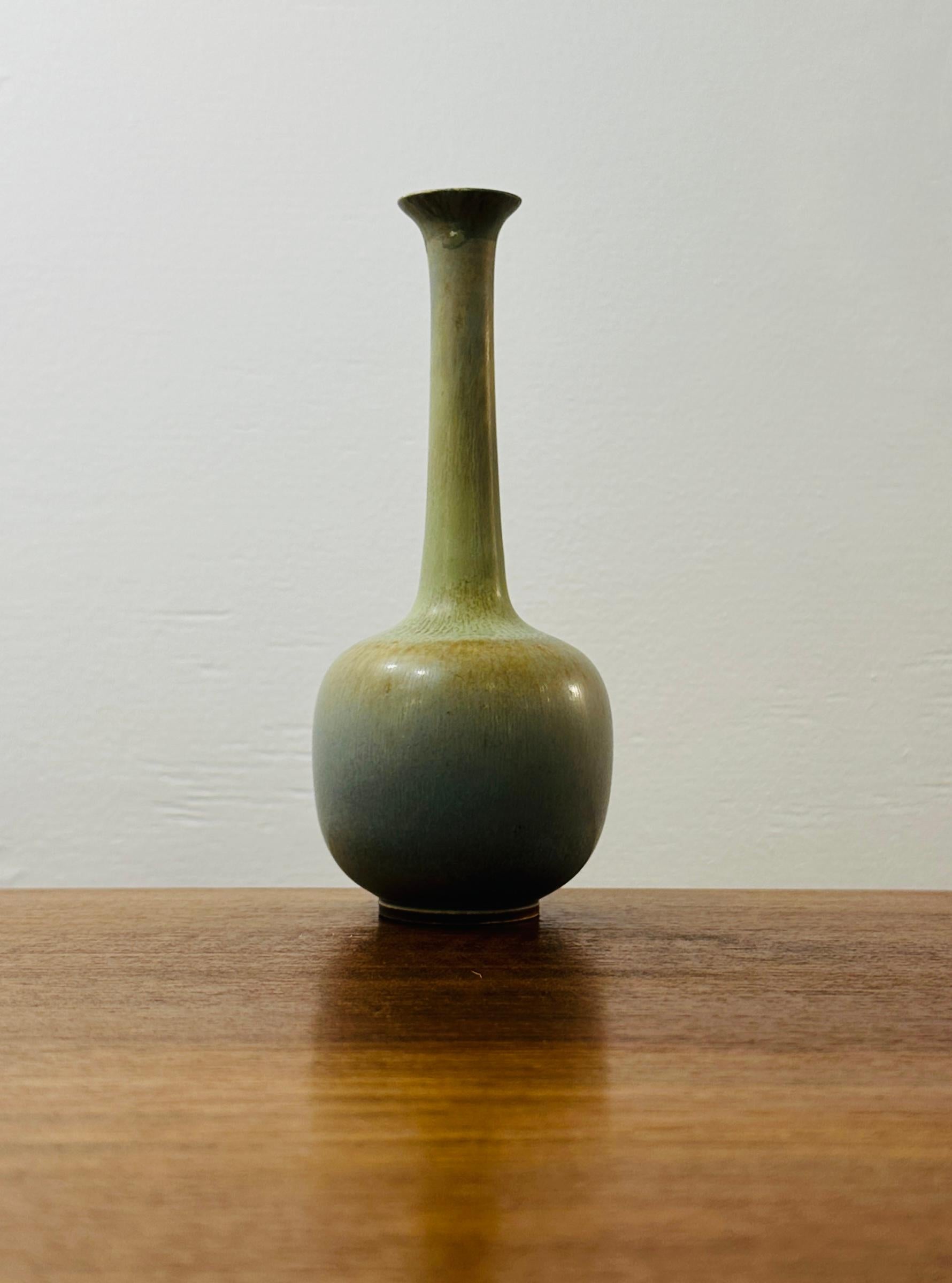 A beautiful light brown-green stoneware vase with hare’s fur glaze which is characterised by a soft dappled pattern.  Designed by Berndt Friberg (1899-1981) who was a Swedish ceramic artist renowned for his wheel-thrown pottery, intricate glazes,