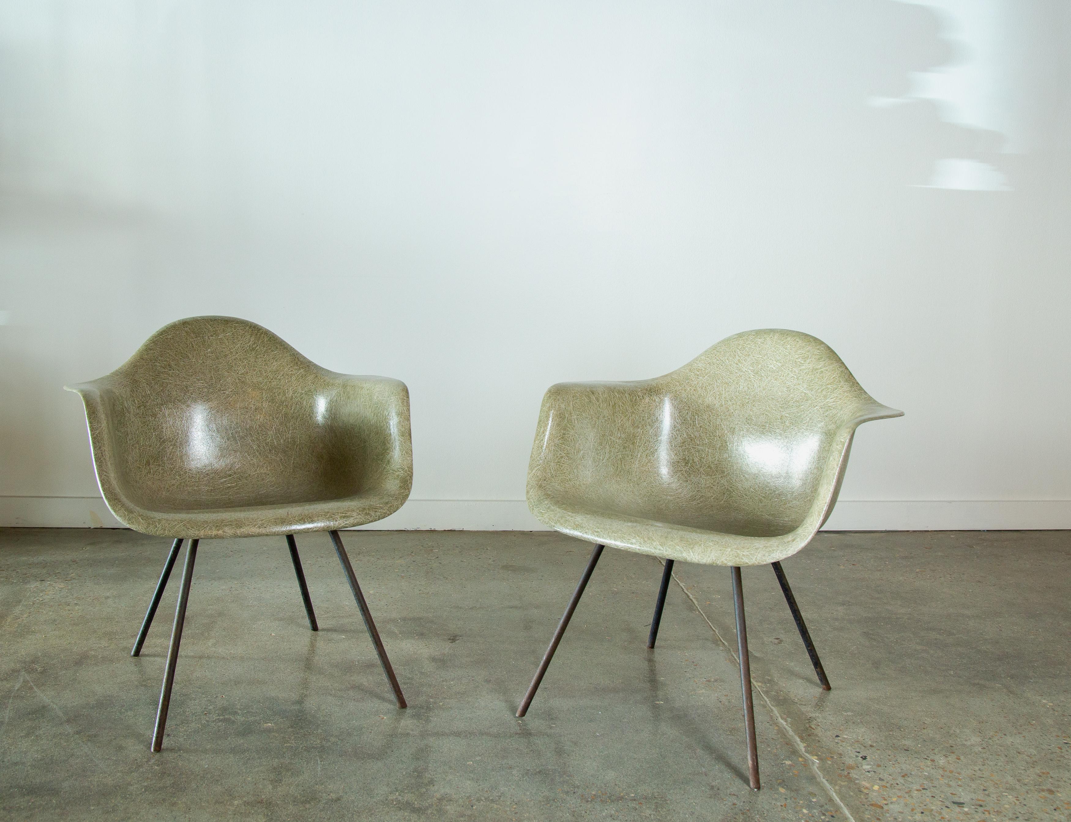 Seafoam shell armchairs designed by Charles and Ray Eames for Herman Miller.  These chairs with 3 dots marked on the bottom of the chair (see last photo) signify 3M manufacturing and date to around 1953.  The fiberglass shows high fiber texturing