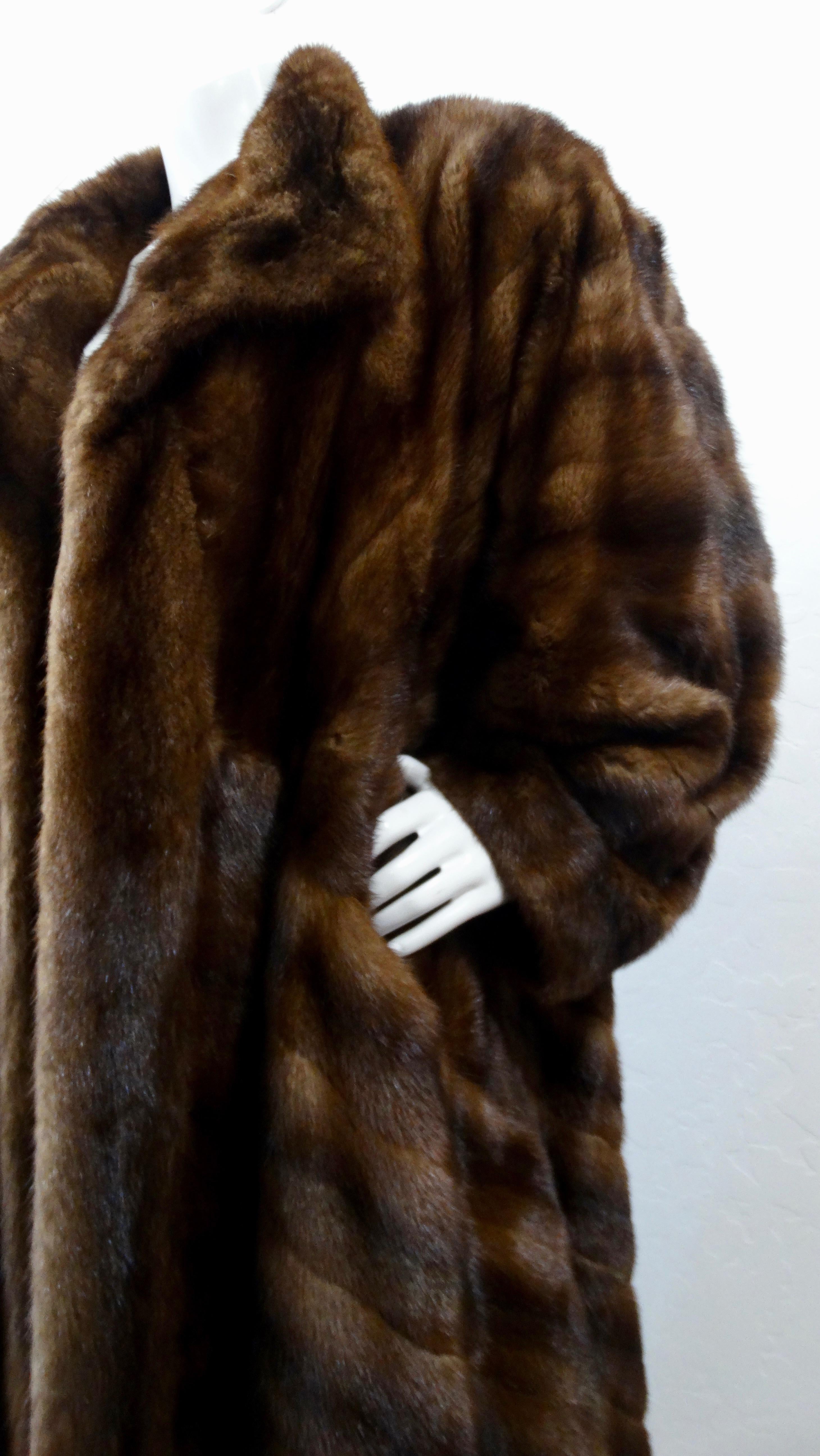 Stay cozy in style all winter long! Circa 1973, this Christian Dior billowy coat is made of gorgeous two-tone brown mink fur. Features a notched collar and fully lined interior. The perfect coat to get you through winter! 