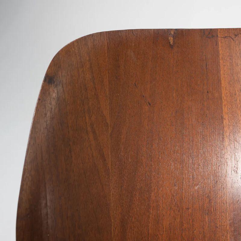 This is An Eames LCW Lounge Chair in Walnut, dating to circa 1953. It has the 5-2-4 screw pattern underneath, indicating early Herman Miller production. This example is in very good to excellent vintage condition with some light wear from use and
