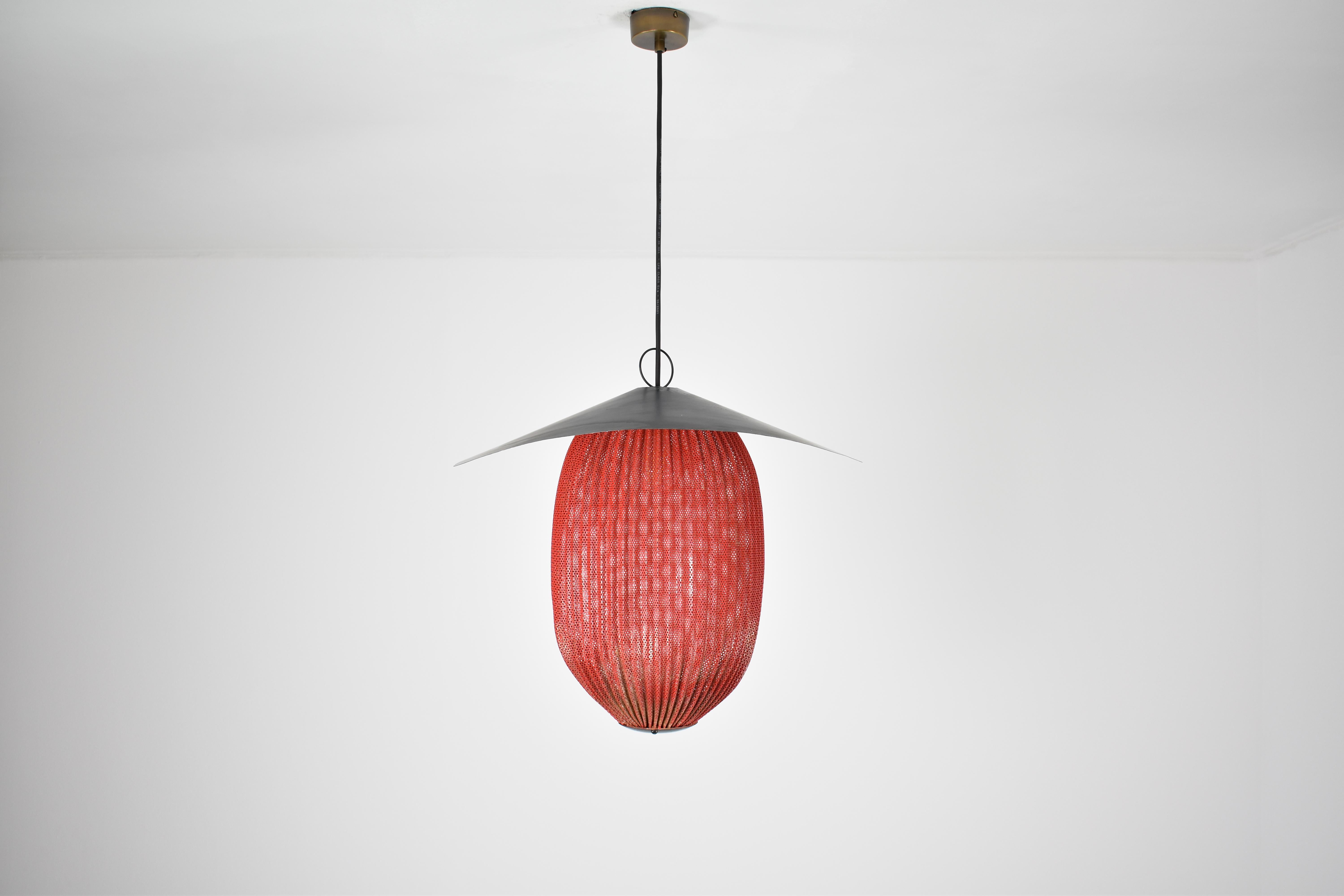 An original first edition Satellite pendant by the iconic French mid-century designer Mathieu Matégot, 1953 in red and black. 
This model is currently being re-edited by Gubi. 
In its original vintage condition. 
Mathieu Matégot's factories were
