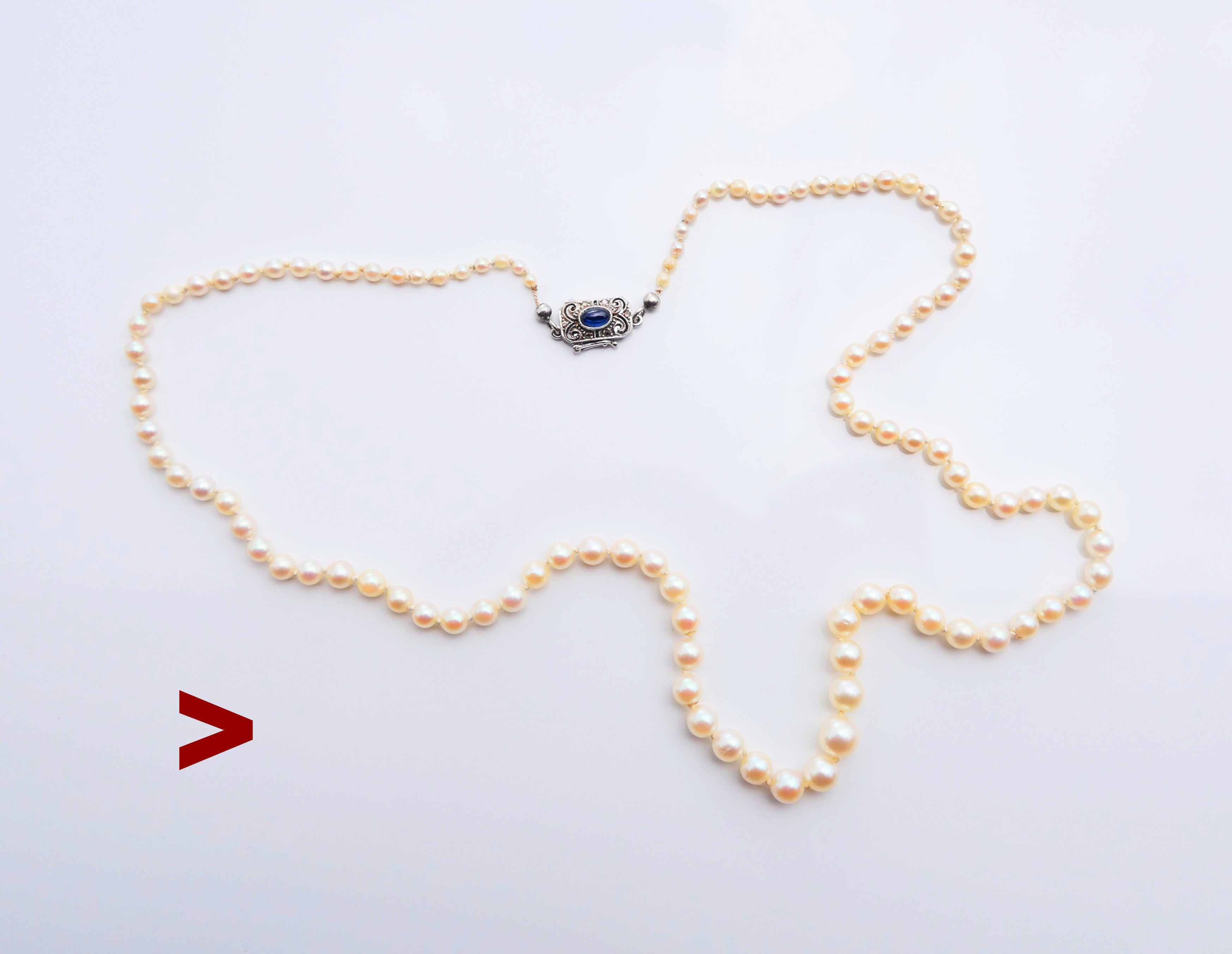Fine Vintage Necklace featuring a beautiful set of gradually sized cultured sea Pearls complemented with original V-lock with safety clutch in solid 18K White Gold decorated with natural cabochon cut Blue Sapphire and rose cut Diamonds .

The lock