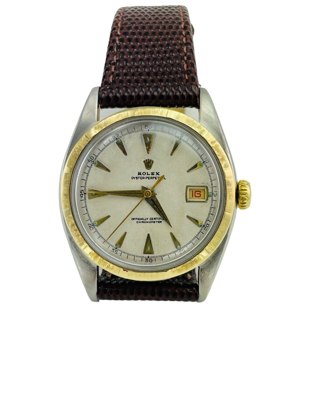 1953 Rolex Bubbleback 14K bezel Gold Stainless Steel Watch Ref. 6105

Vintage Rolex Bubbleback with a 14k yellow gold bezel and stainless steel case, ref: 6105  The watch case is attached to a leather band with an authentic Rolex buckle. This is a