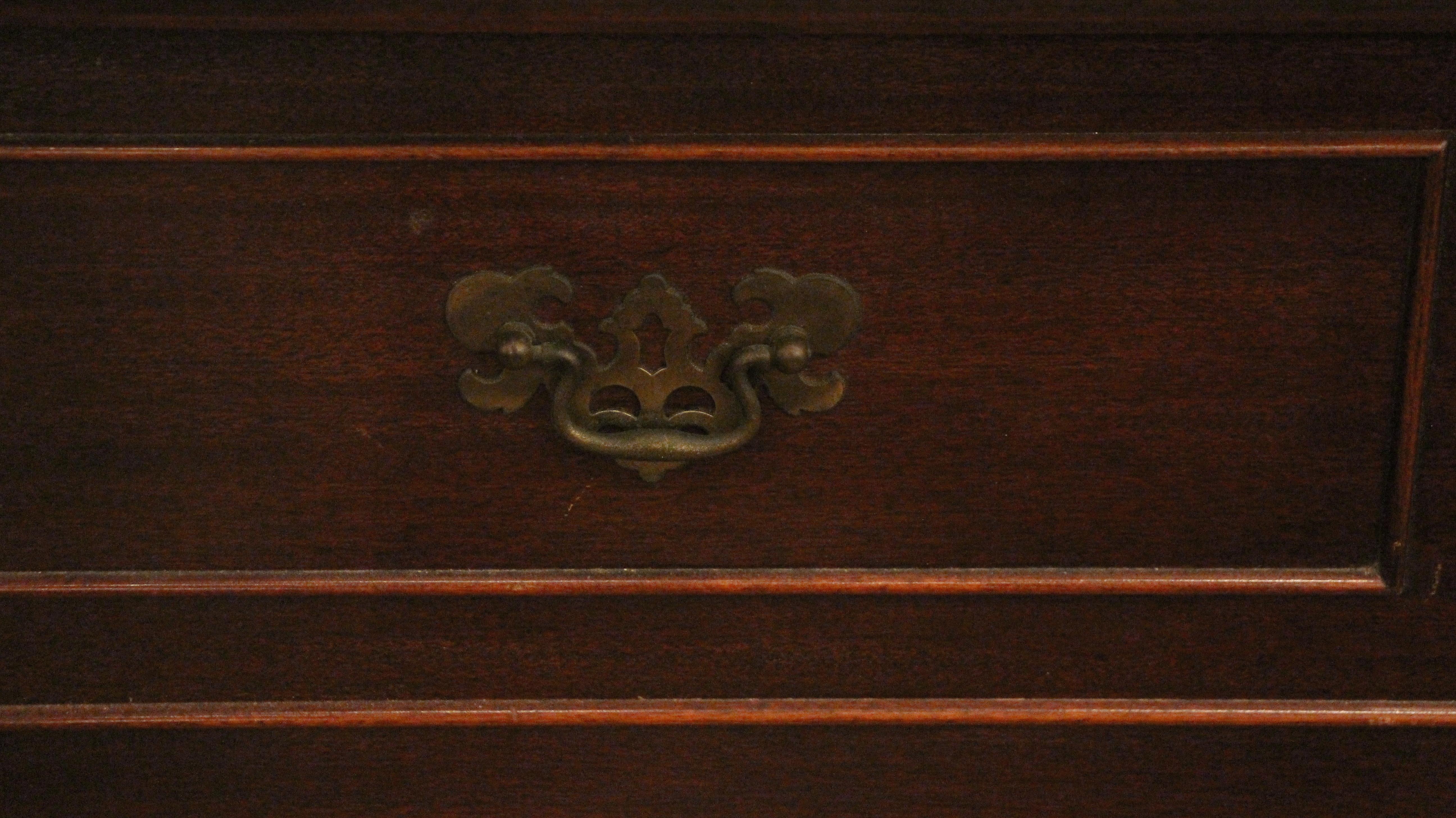 Dark wood tone lane cedar or blanket chest made of mahogany with carved decorative details. Dated to 1953. There is some minor damage to the metal support inside, but the overall condition is excellent. This can be seen at our 2420 Broadway location