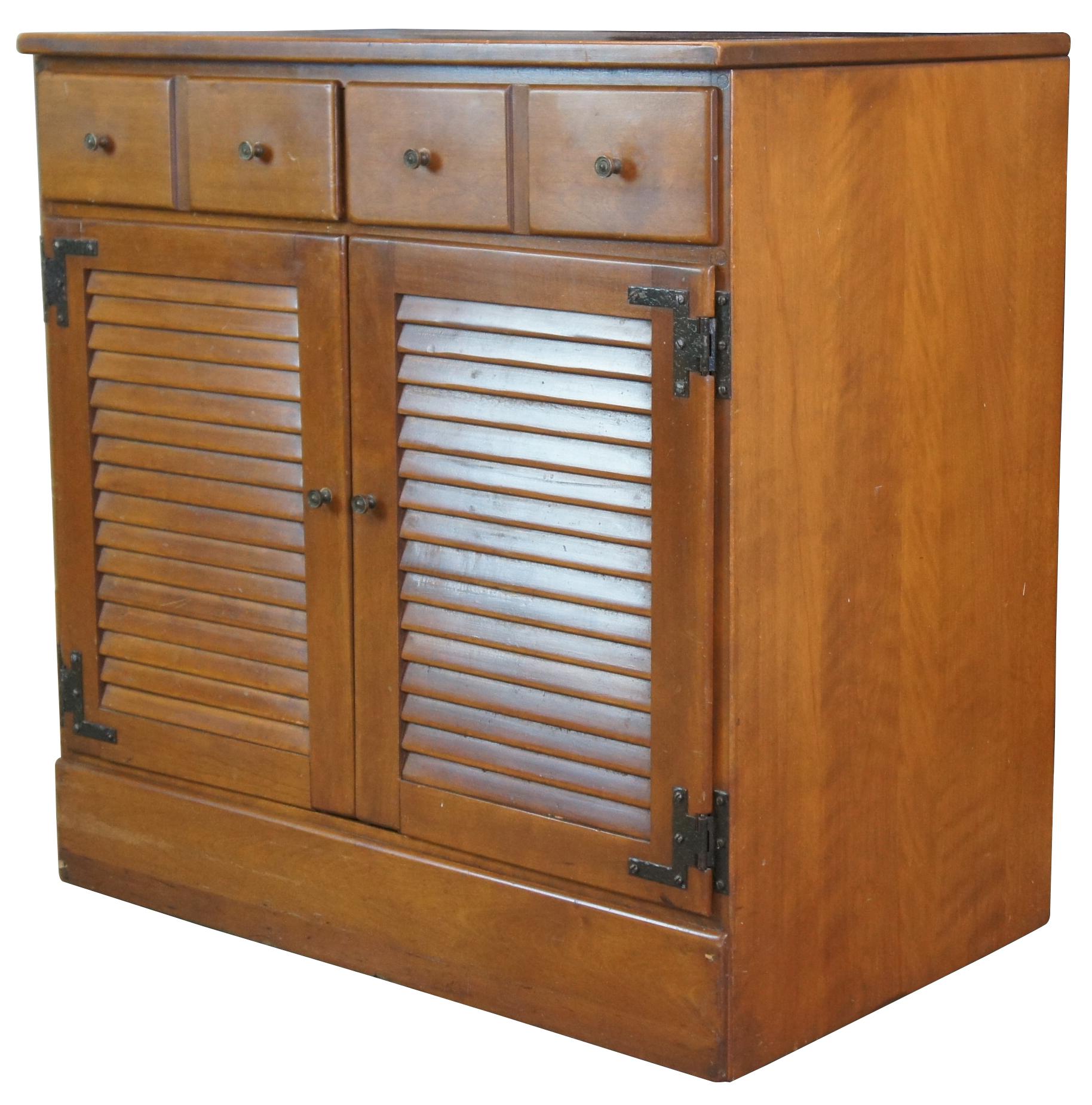 Mid century Baumbritter Ethan Allen Heirloom shutter door cabinet, side table, or console. Made of maple featuring rectangular form with lower cabinet and upper drawers. Circa 1954. Nutmeg Finish. Measure: 30
