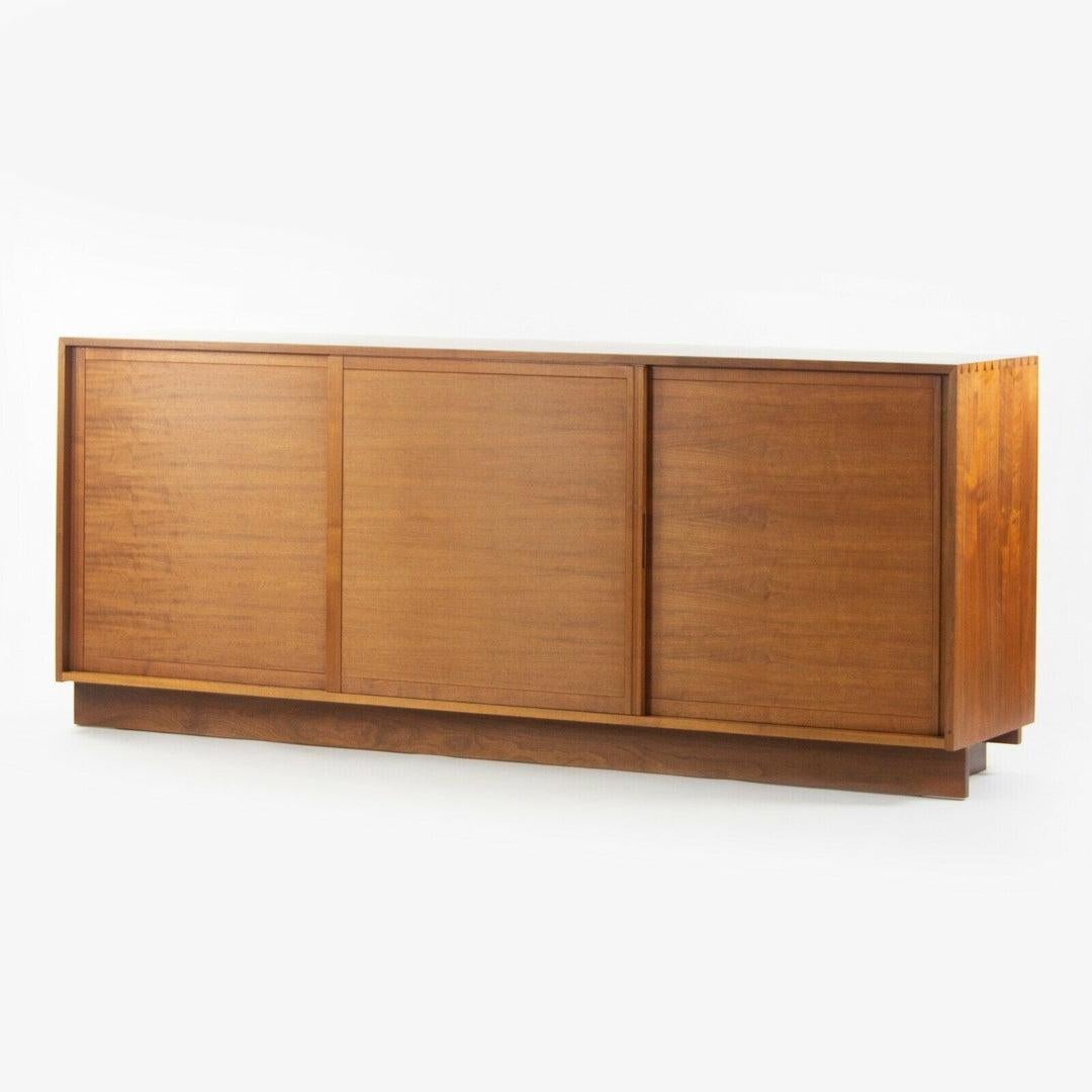Listed for sale is a gorgeous 1954 George Nakashima Studio triple sliding door cabinet /credenza in American black walnut. This is an early piece, representing a number of refined early and recognizable details. This piece has the characteristic