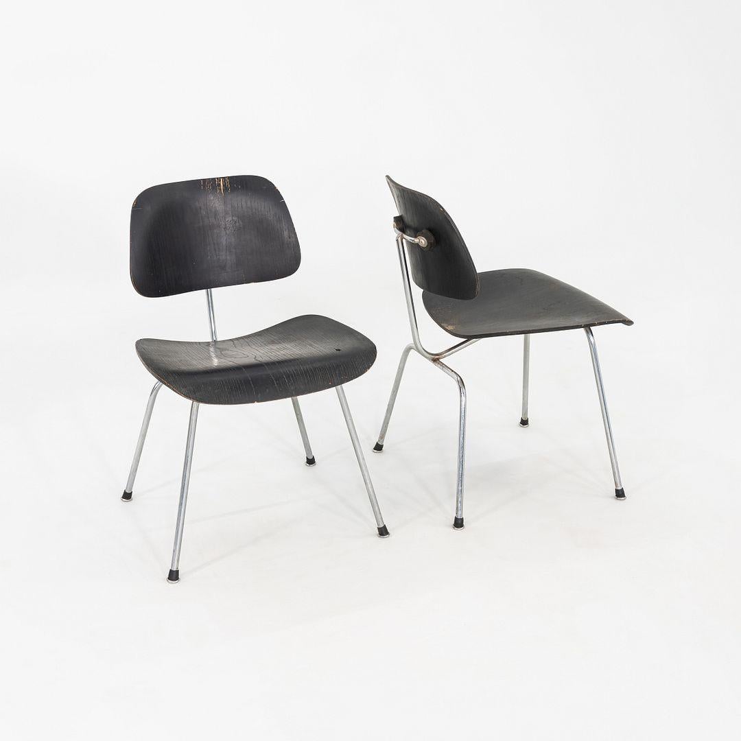 This is a Pair of DCM Chairs, designed by Charles and Ray Eames in 1946. These examples were produced by Herman Miller in ca. 1954. The design features a bent-plywood seat and back, and has tubular chromed-steel legs. The wood on these examples was