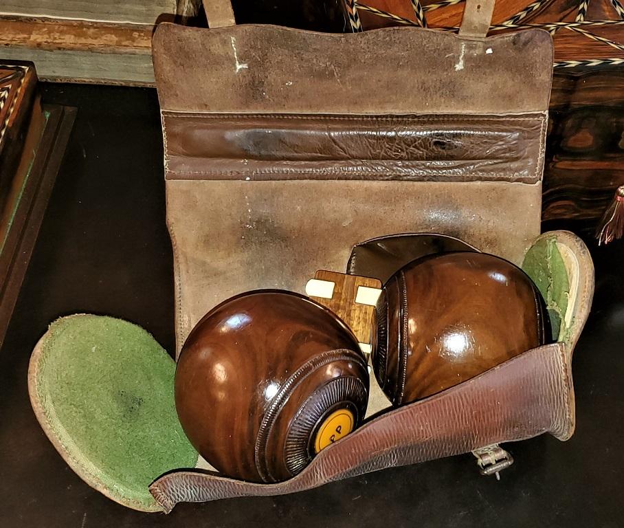 Presenting a lovely 1954 pairof English EJ Riley Lignum Vitae Lawn bowls.

In original brown leather case with original ivorine counters and clip.

Both bowls are fully marked as being made by the famous English maker E. J. Riley Ltd of