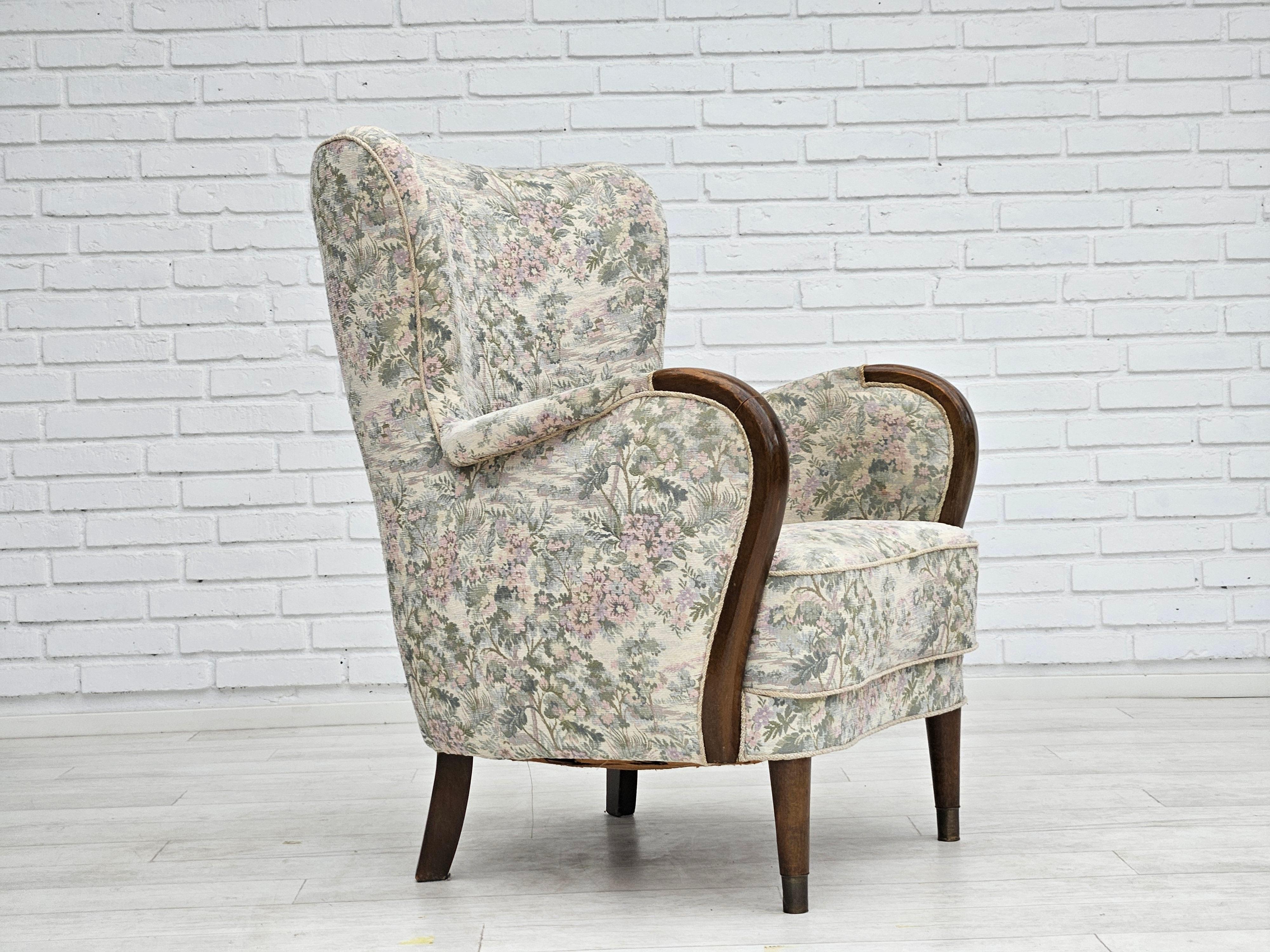 1950-60s, Danish design. Armchair in floral light fabric. Good condition: no smells and no stains. Legs and armrest in beechwood. Front legs with brass plugs. Brass springs in seat. Manufactured by Danish furniture manufacturer in about 1955s.